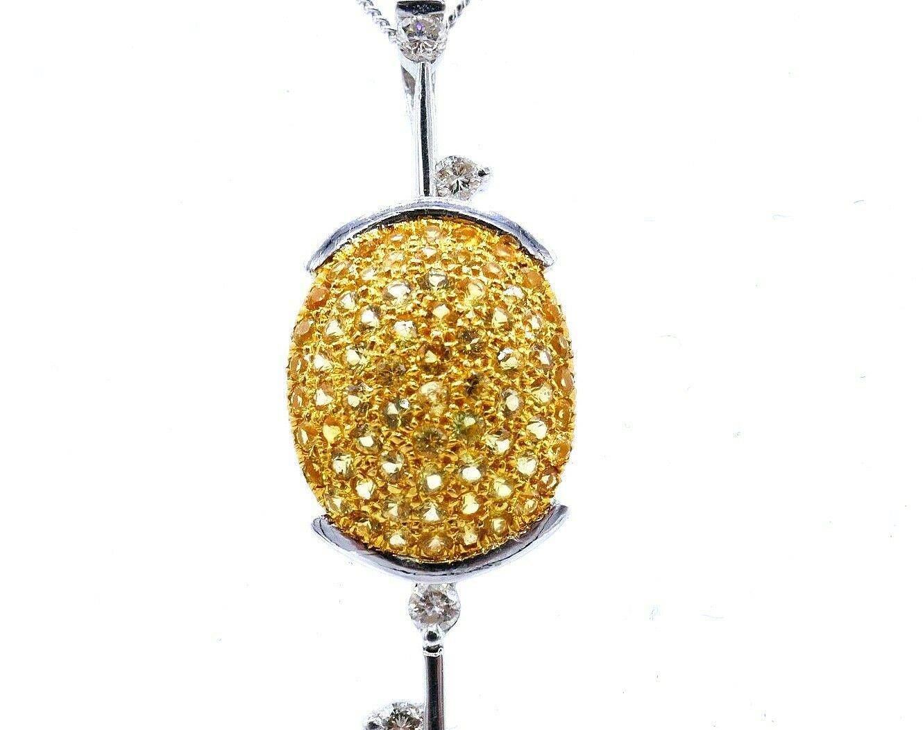 Beautiful stylized Golf Club pendant made of platinum and yellow gold featuring yellow sapphires, diamonds and a pink tourmaline. Total carat weight of diamonds is 0.54 points, they are round brilliant cut.  Comes with a 14k (stamped) white gold
