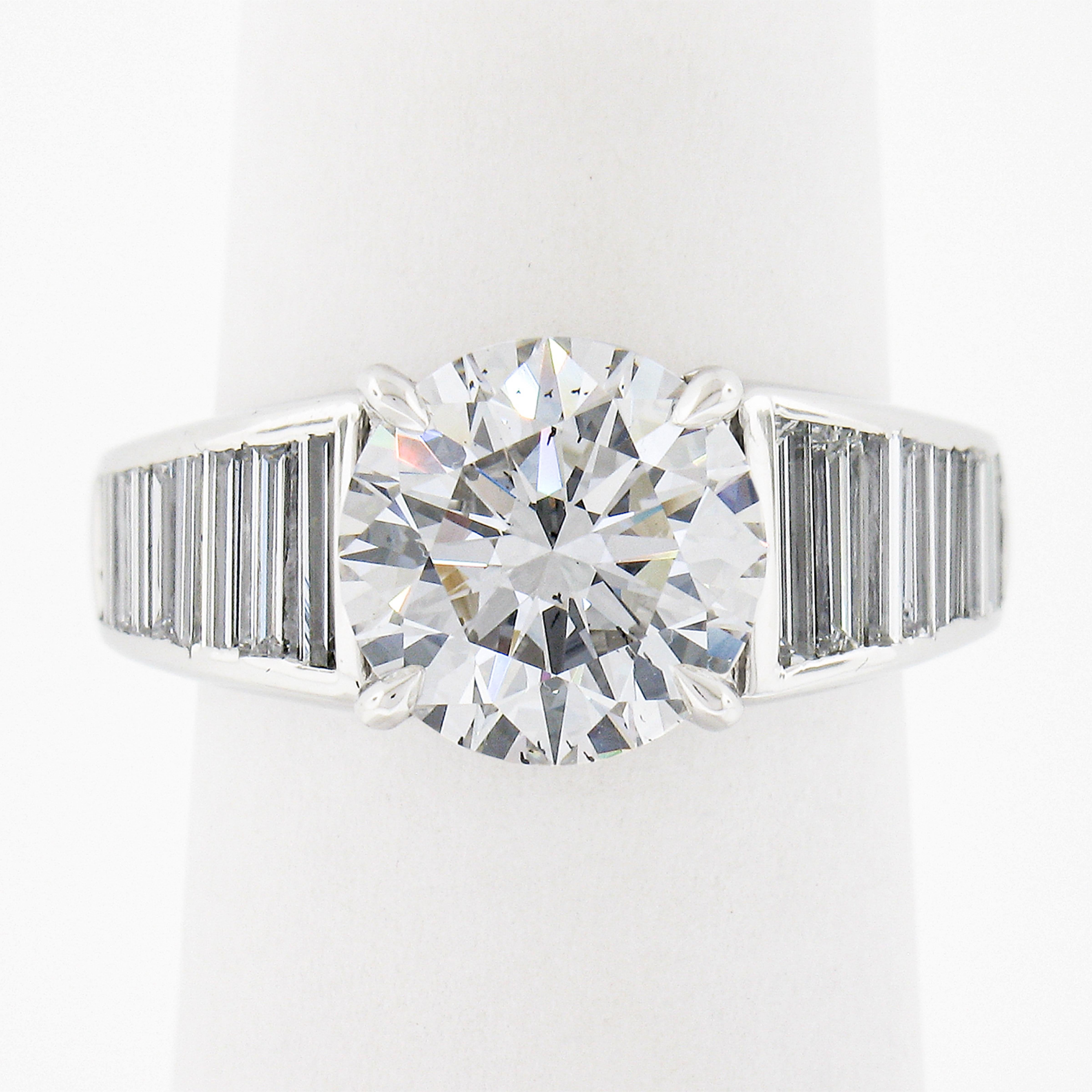 This ring features a GIA certified top quality 3.17ct center round brilliant diamond. The diamond has an Ideal Cut and an incredible white G color along with a 100% eye clean SI1 clarity. Such a diamond deserves a setting that is just as fabulous.