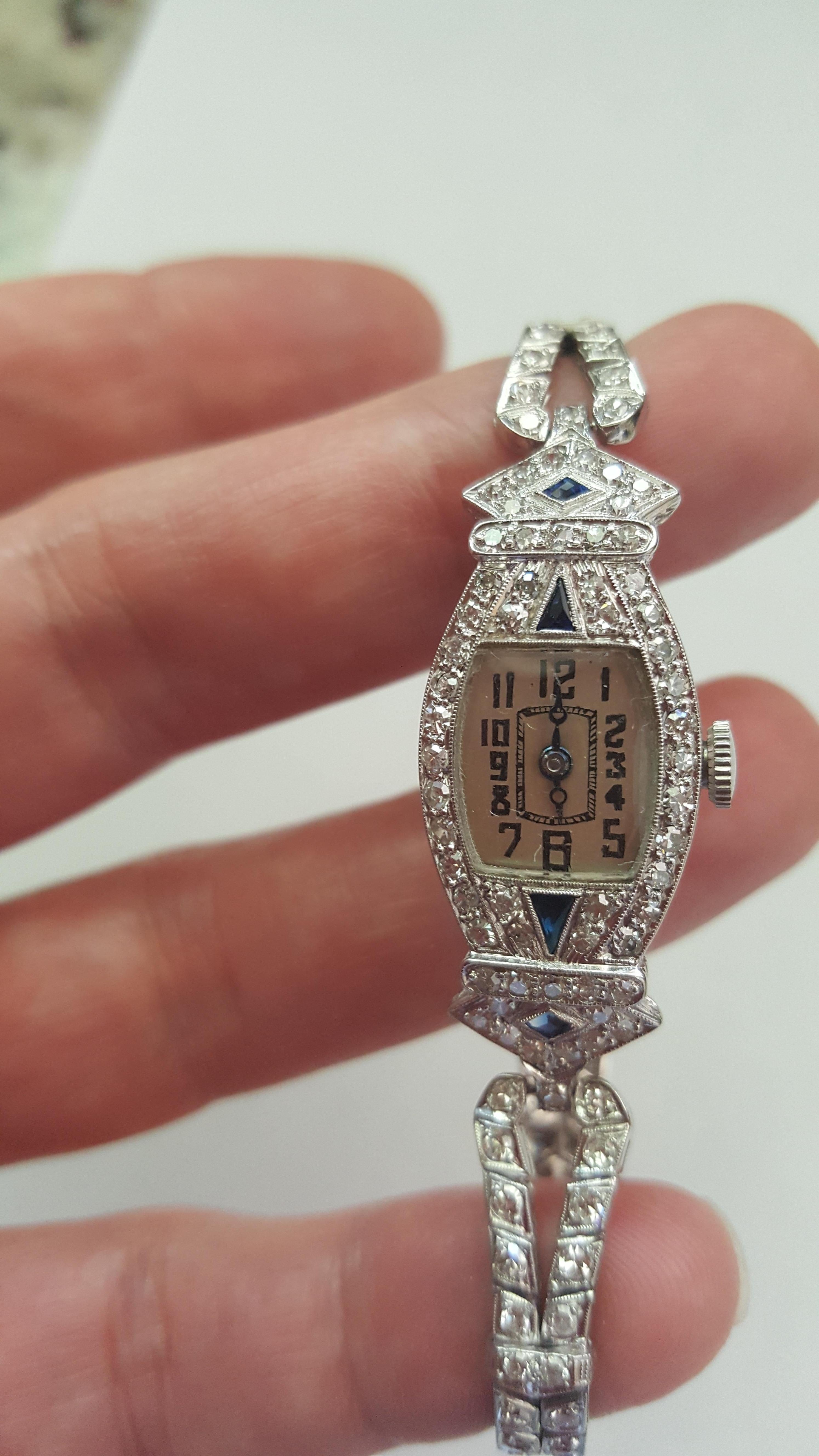 Vintage 1920's Platinum Glycine Ladies Watch With 114 Single Cut Diamonds of approximately 3.56cttw and 4 Triangle and Diamond Cut Sapphires, Hand Engraved, 21.7 grams, Excellent Condition, Petite. The diamond are white and clean. This watch has