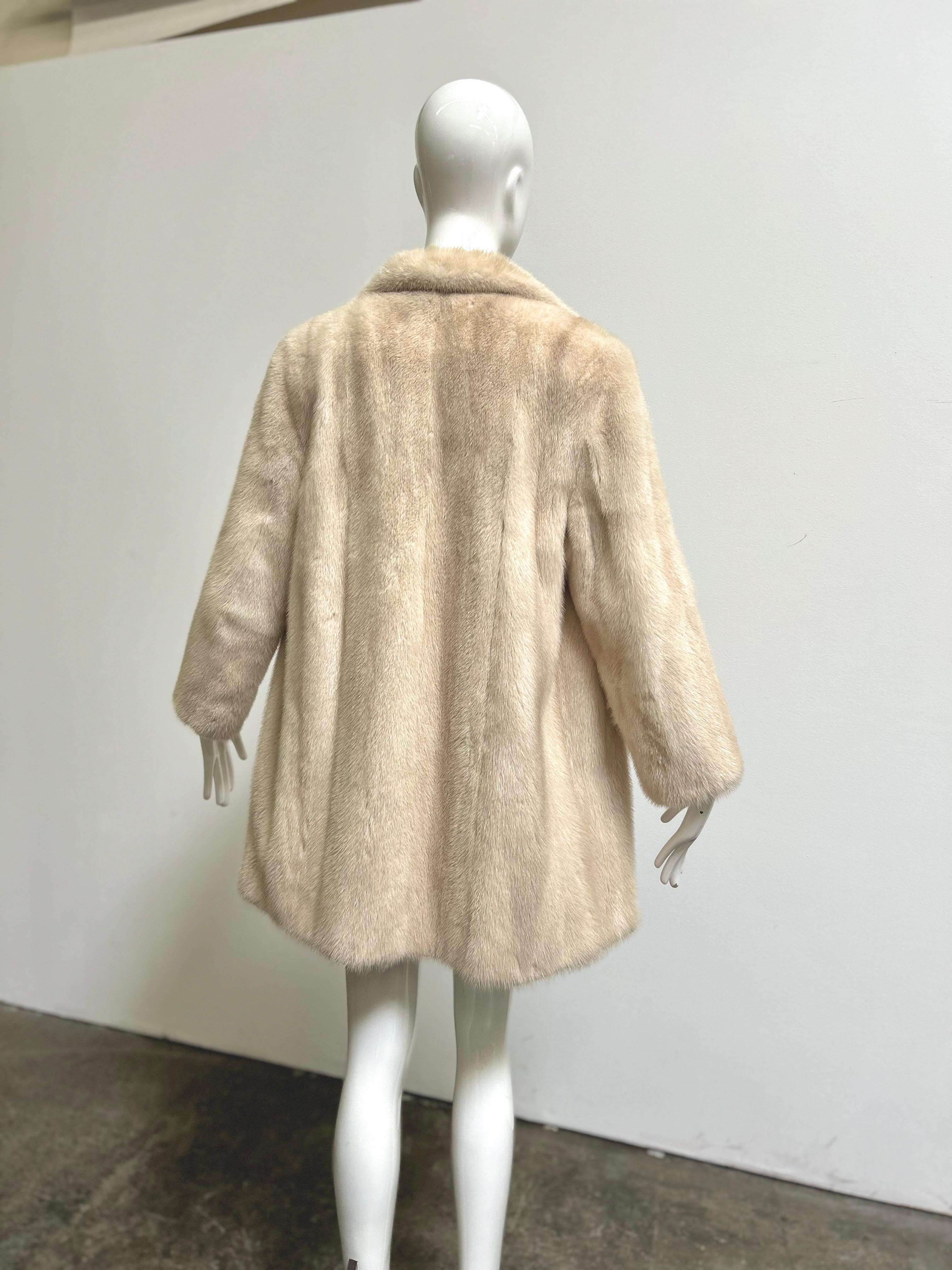 Vintage off white platinum mink fur coat by Conklin Furs. Front hook closure and velvet lined pockets. Sleeves have 2.5
