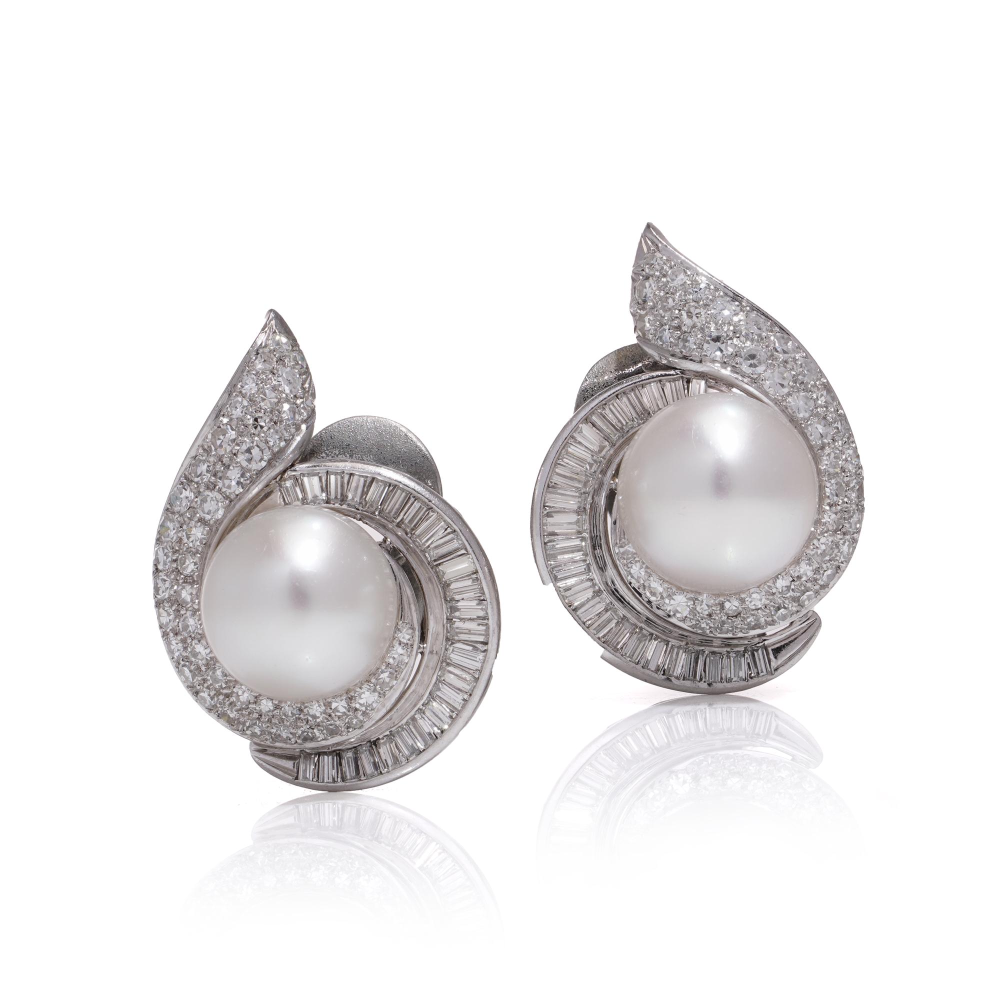 Vintage platinum earrings featuring a pair of cultured South Sea pearl diamond cluster clip-on. The earrings are hallmarked with a 
