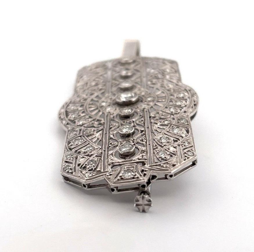🡆 Offered is an elegant and finely crafted Art Deco–inspired brooch pendant, set in platinum, featuring a mix of round brilliant, transitional, and single-cut natural diamonds. This piece showcases intricate bezel and bead settings, and a