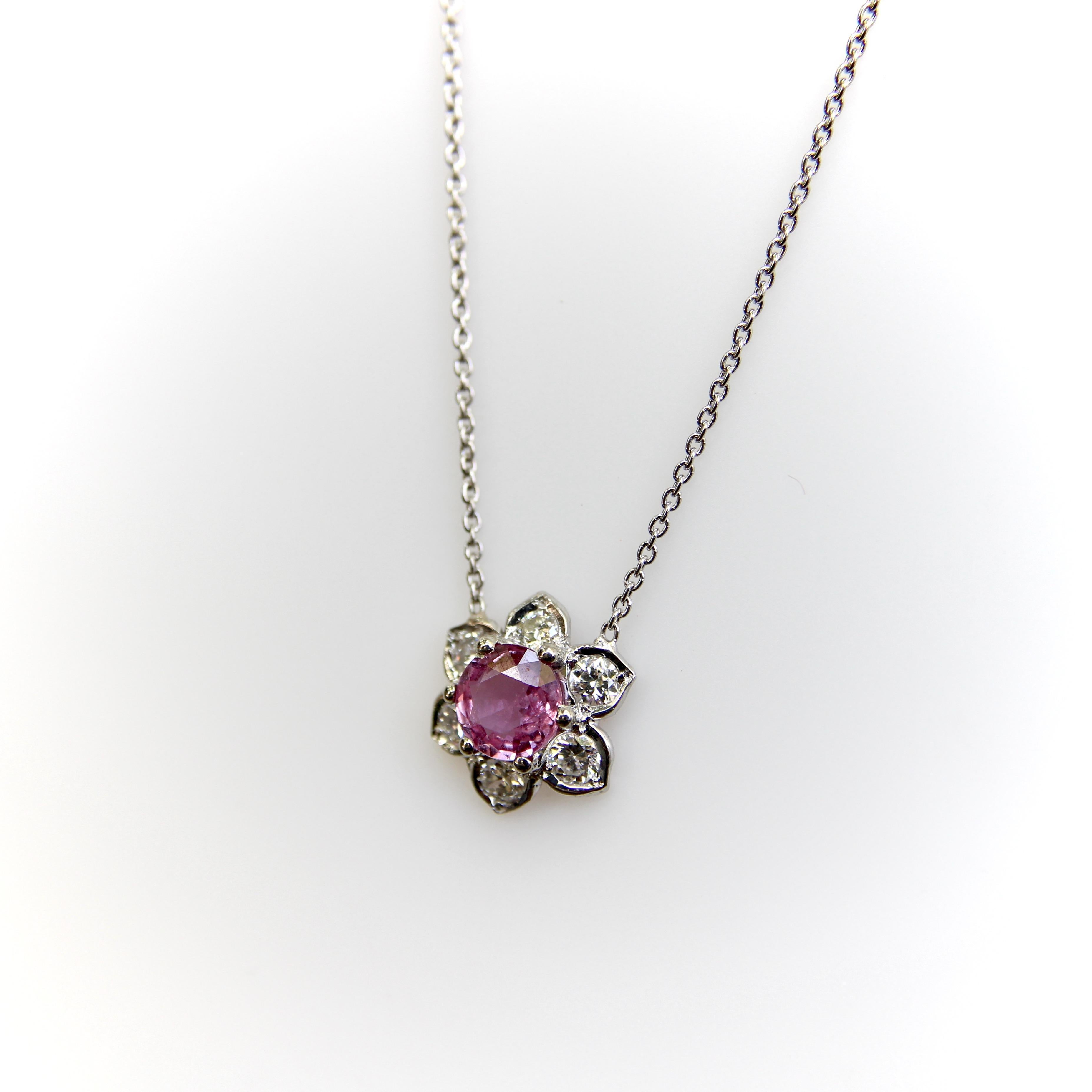 If Flower Power is your language, then this is a perfect piece for you! This vintage setting is made of platinum and houses six 3.2 mm diamonds, centered around a 6 mm natural pink sapphire. Each of the diamonds makes a flower petal, bead set into a