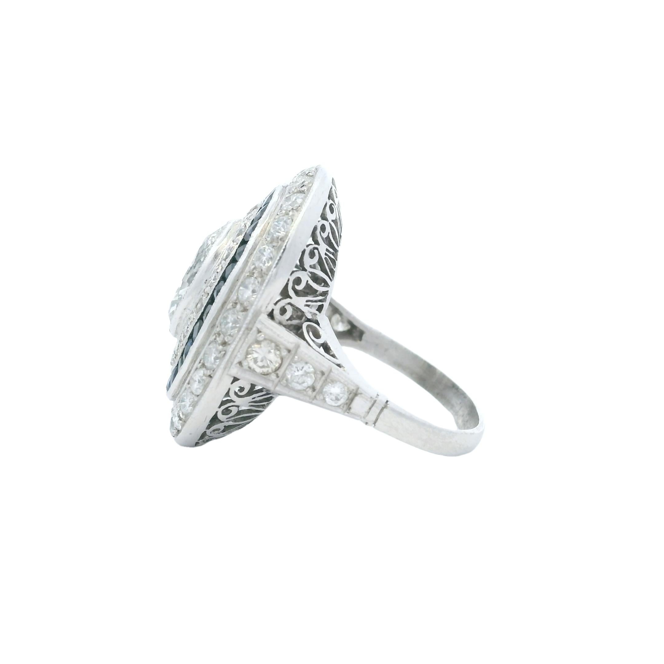 Step into the elegance of the Jazz Age with this breathtaking Art Deco cocktail ring, masterfully handcrafted in platinum. At its heart lies a mesmerizing marquise-cut diamond weighing approximately 1.40 carats, radiating brilliance and