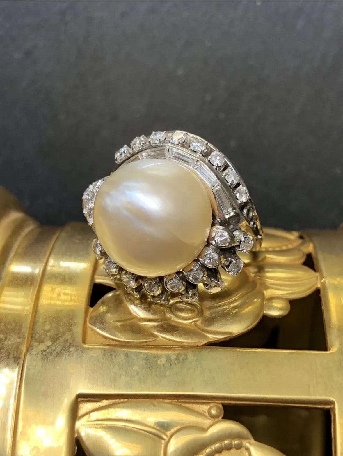 An original retro cocktail ring Circa the 1950’s done in platinum set with approximately 1.08cttw in H-I color Vs2 to i1 clarity round and baguette diamonds centered by a 13.47mm baroque, freshwater pearl.


Dimensions/Weight:

Ring measures .75” in