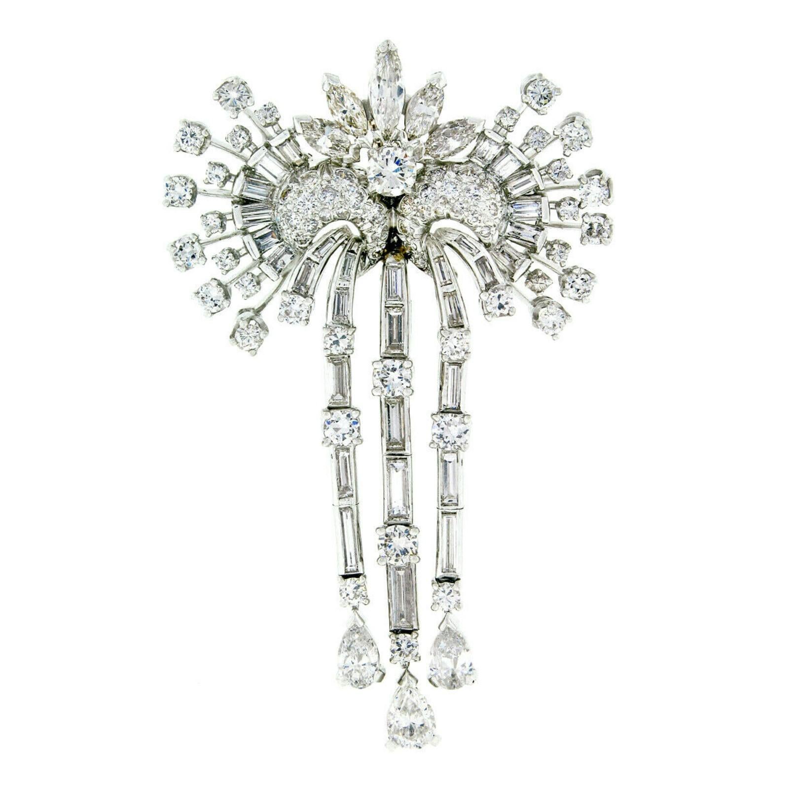 This magnificent diamond brooch pendant was crafted from solid platinum during the mid-century and features approximately 10.45 carats of very fine quality diamonds. The pendant has a look similar to that of ornate masquerade or mardi gras masks.