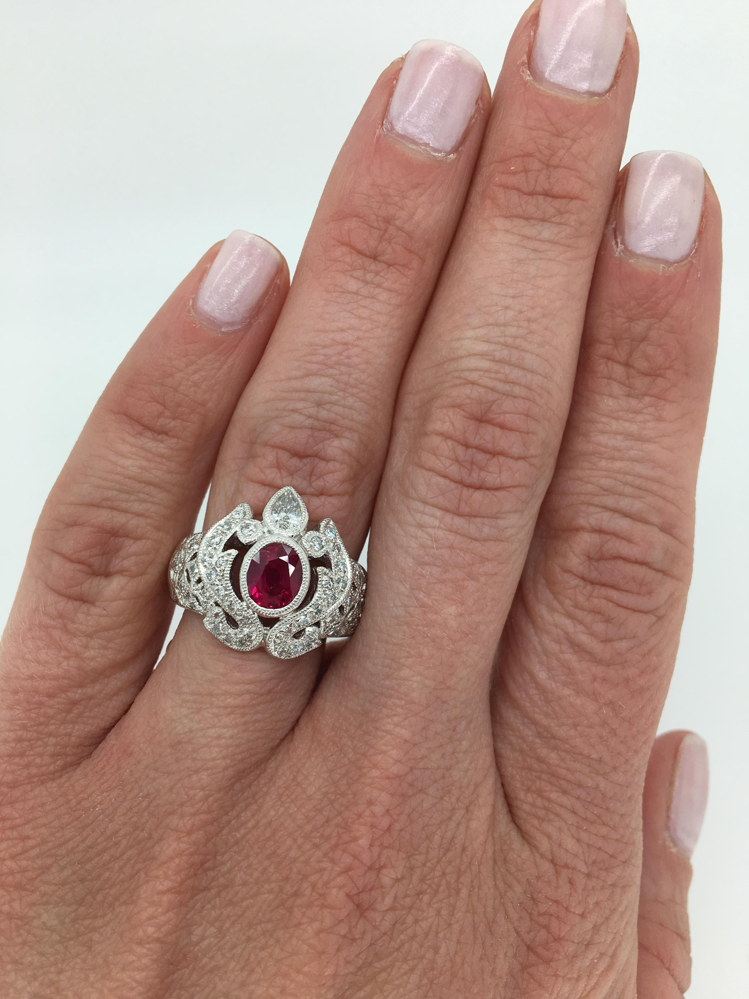 Unique vintage inspired Ruby and Diamond ring crafted in platinum.

Gemstone: Ruby & Diamond
Gemstone Carat Weight: Approximately .92CT Oval Cut Ruby
Diamond Carat Weight: Approximately .86CTW
Diamond Cut: Round Brilliant 
Color: Average