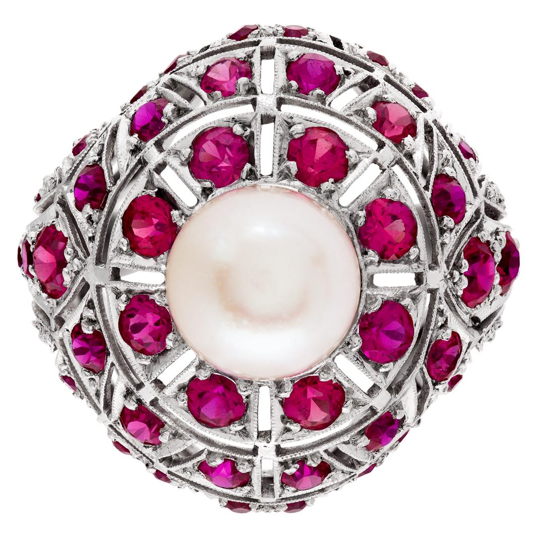 ESTIMATED RETAIL: $8,400.00 YOUR PRICE: $5,940 Unique vintage ruby & pearl ring with approximately 1.50 carats in blood-red rubies and approximately 8.70 mm center pearl in platinum Size 4.75.