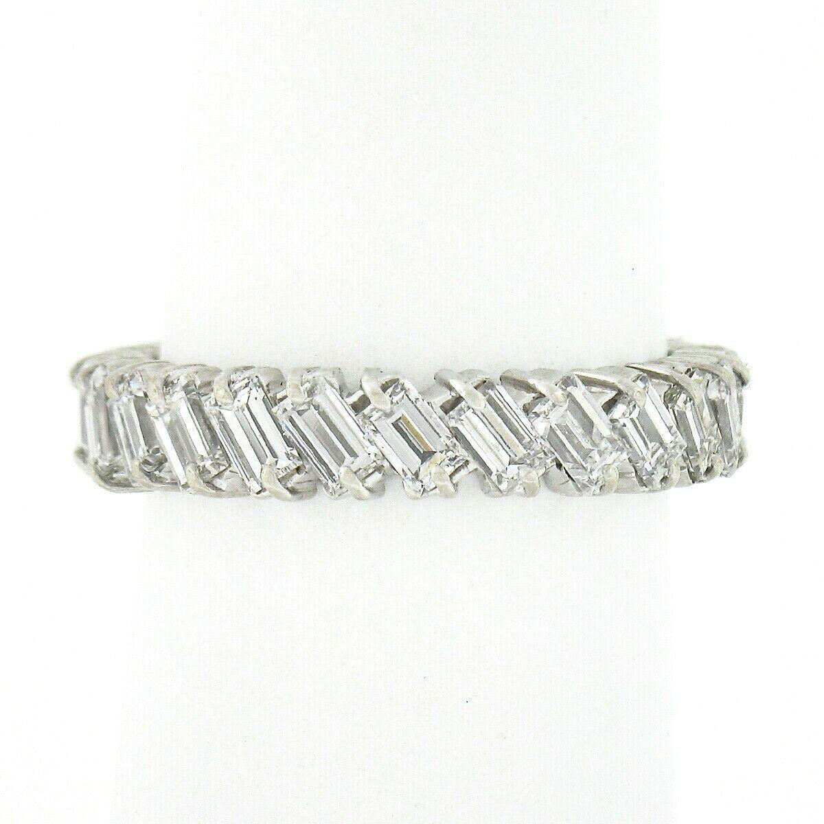 This absolutely gorgeous vintage eternity band ring is crafted in solid platinum and features 24 SUPER FINE quality straight baguette cut diamonds uniquely set at a slant entirely throughout the band. These stunning diamonds total approximately 2.88