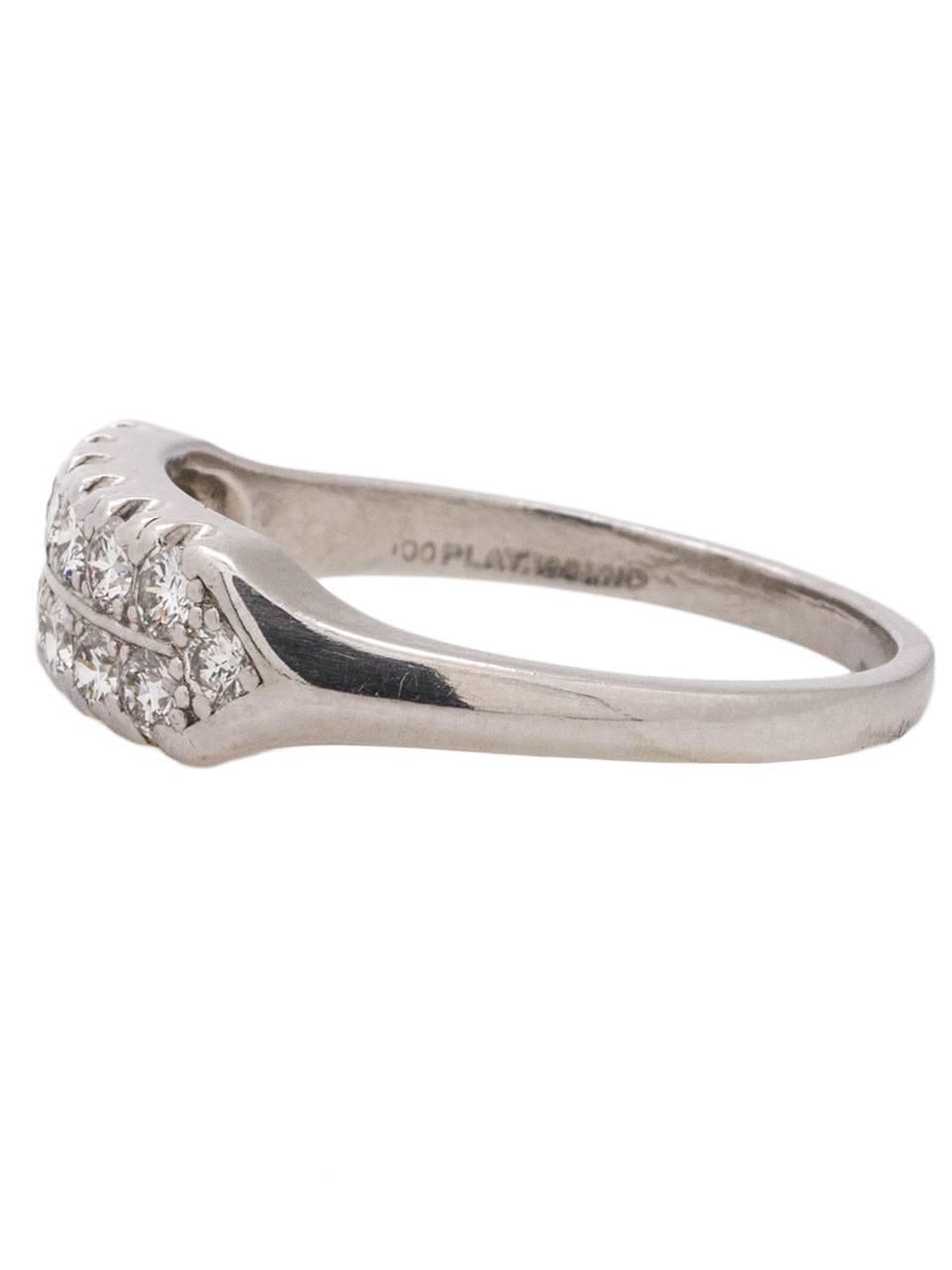 
Stunning Retro platinum band with a double row of bright and fiery full cut round brilliant diamonds, approximately 0.68 carat total weight, F-G/VS2-SI1. Fish tail settings and a softly beveled tapered shank complete this beauty. Top of ring