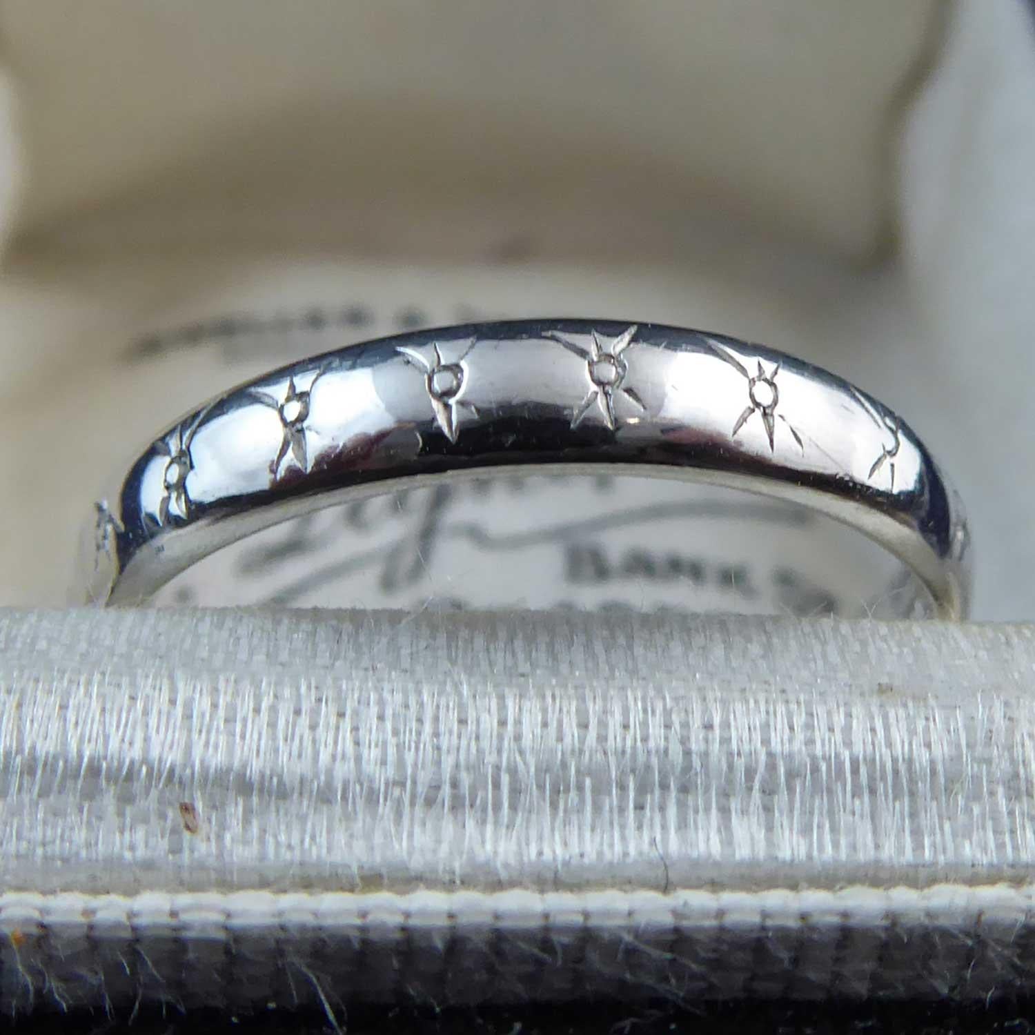 Mid-century vintage wedding ring fashioned in platinum with an elegant pattern engraved all around.  The band is a D shaped cross section and measures approx. 3.0mm wide.  Finger size 6.5 (US/Canada), N (UK/Australia) with some resizing possible