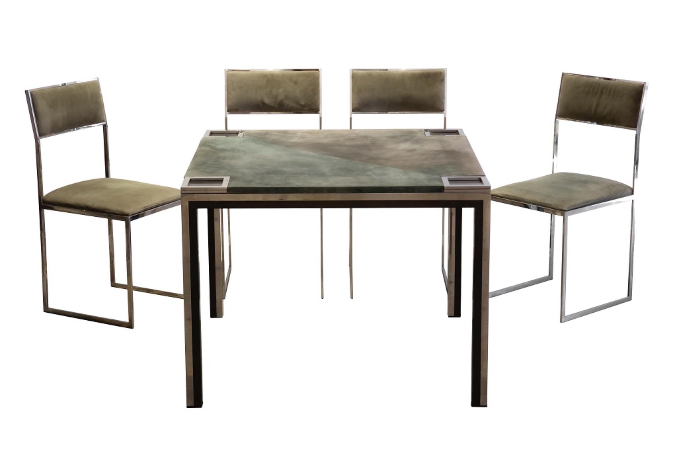 Play table with chairs is an original design work realized in the 1970s by Willy Rizzo (Naples, 1928 - Paris, 2013).

Created by Willy Rizzo.

The work includes a table and four chairs. 

Made in Italy.

Chamois and steel.

Dimensions: 76
