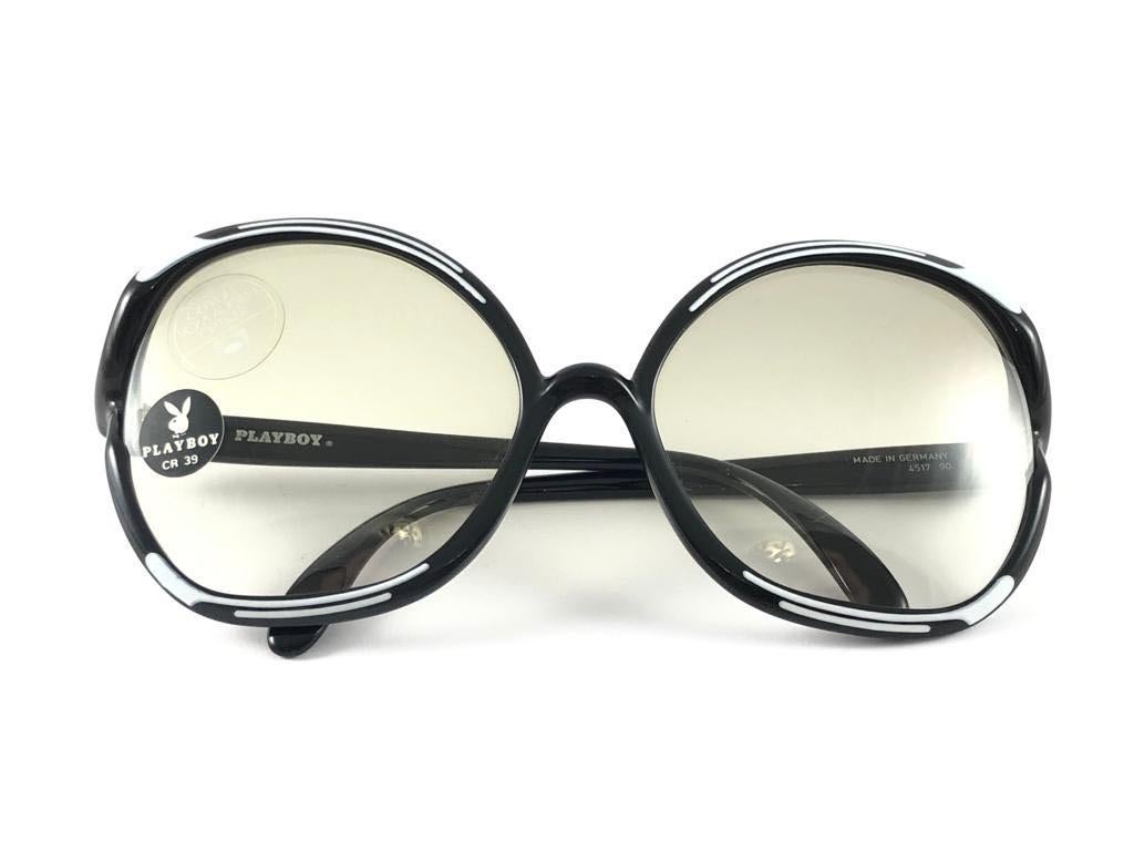 Vintage Playboy by  Optyl black and white frame sporting gradient light lenses. 

Made in Germany.
 
Produced and design in 1970's.

This item show minor sign of wear due to storage.


FRAME WIDTH  14.5 CMS

LENS HEIGHT  5.5 CMS

LENS WIDTH  5.5