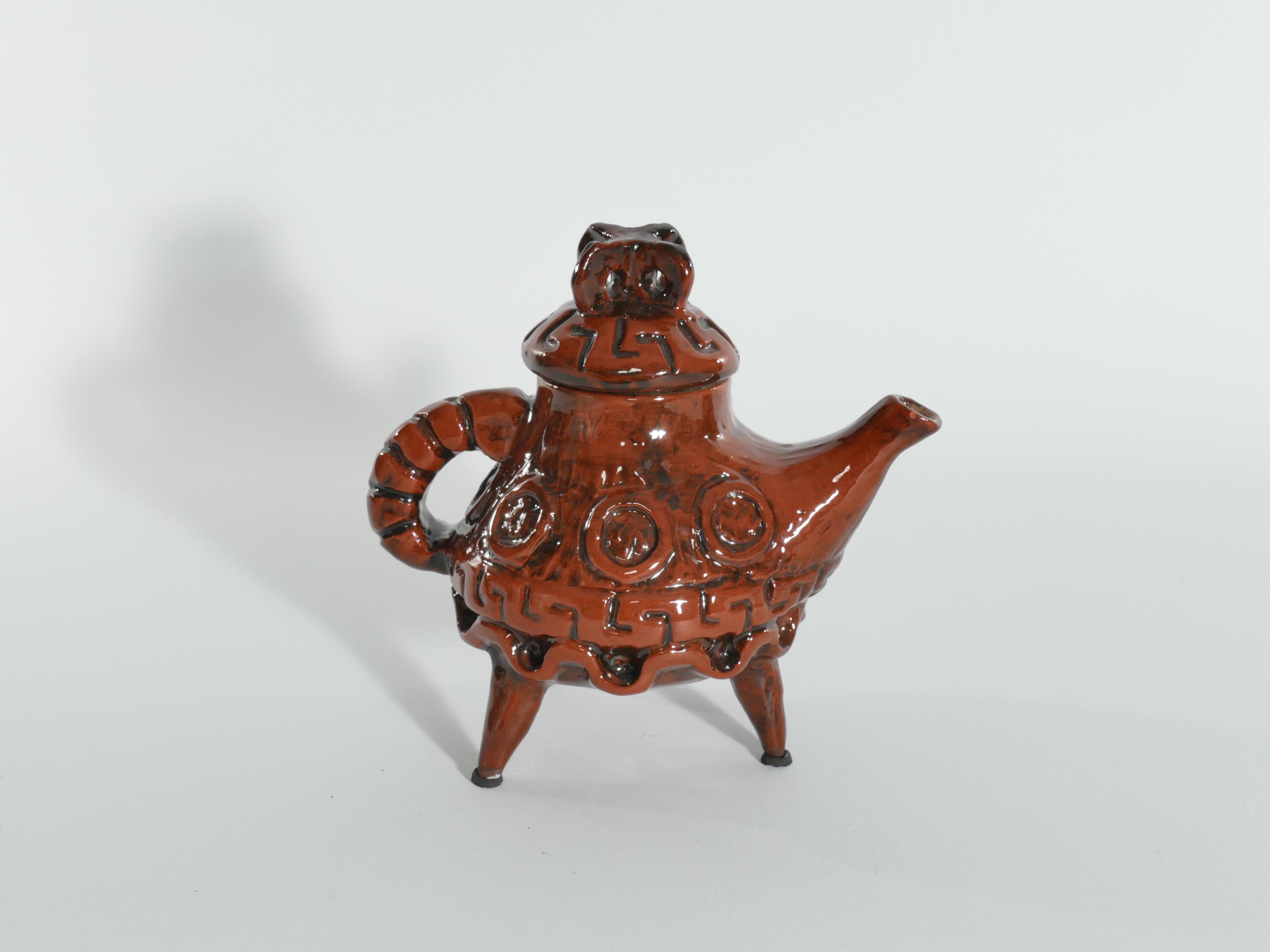 This playful and unique teapot, has different sides to it. Sometimes it looks like just a quirky tea pot with a bright green inside. But in the view from some angles , this three legged teapot looks like an crab ready to run away! 

Allan Hellman
