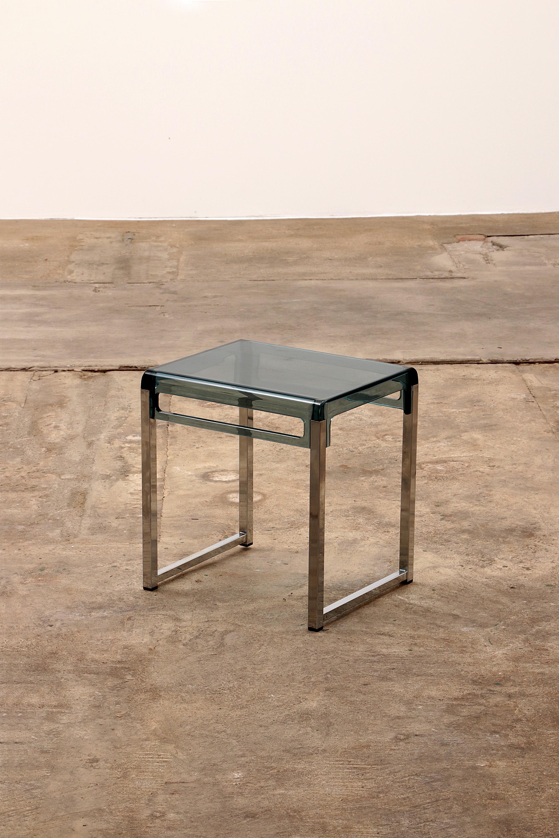 This is a nice side table or can be used as a bedside table.

This is a design by Marc Berthier.

Made of a metal base with a plexiglass top.

The table has a blue plexiglass top and a beautiful chrome base.

Handy to grab it with a party.