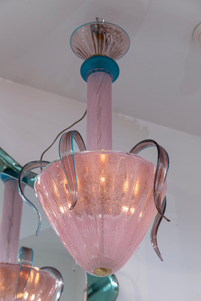 Whimsical Murano chandelier shown with ten cascading leaves in hues of plum and turquoise. While the fixture is composed of vintage glass the lamping and frame is recent 

The glass canopy may install directly flush to the ceiling or this fixture
