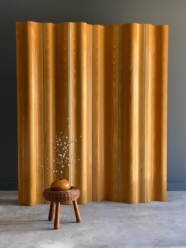 Stunning vintage plywood divider by Charles and Ray Eames, for Herman Miller. Model “FSW-6” (folding screen wood) was designed and released to market in 1946. Consists of six adjustable molded ash plywood joined by canvas. Each segment can be