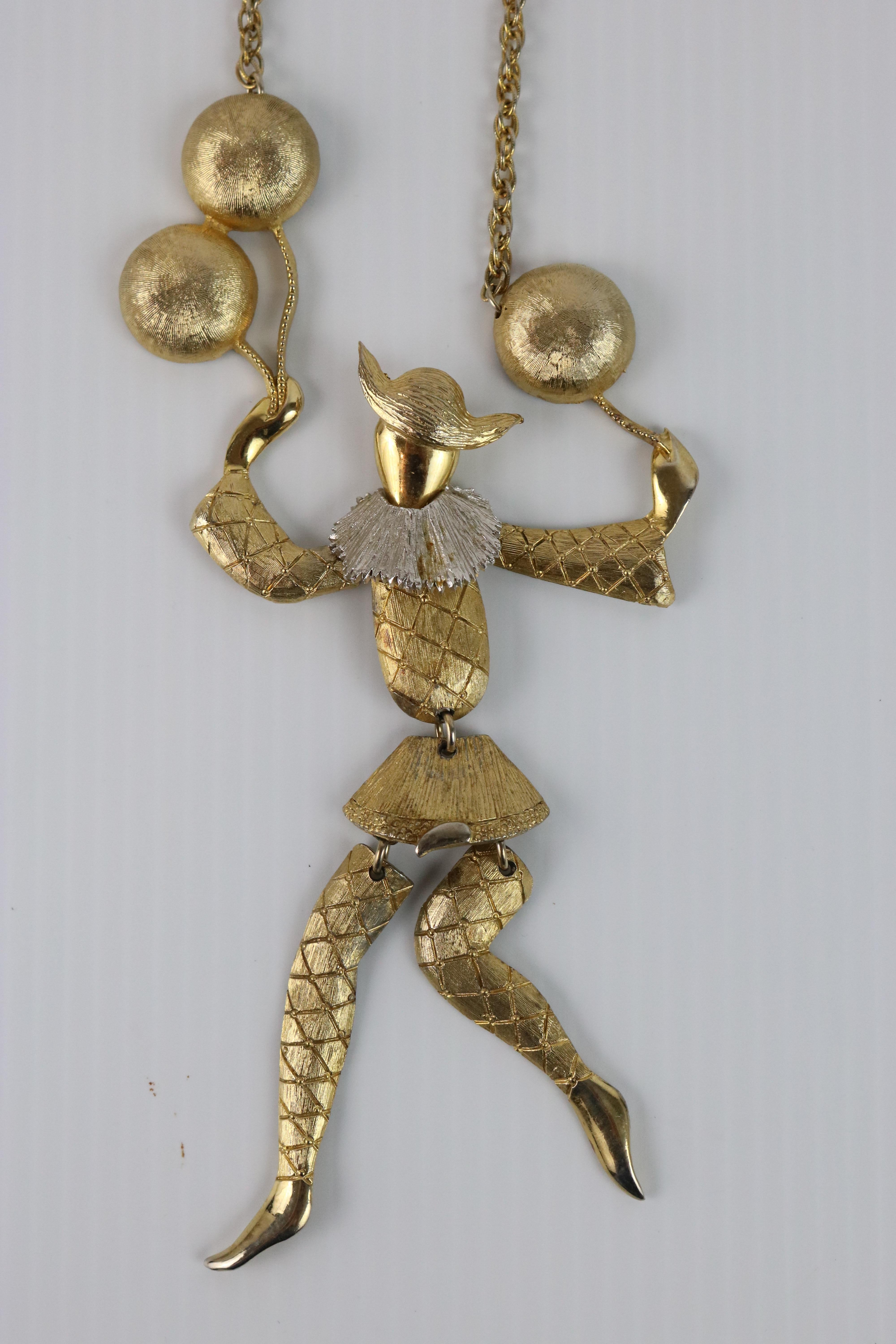 An Adorable Fun Piece to Show-off!
Vintage Romantic Sensuous Gold Plate Articulated Harlequin Figure Floating on Balloons--
Hangs from a chain on the Neck in Articulated Movement as You Move. circa 1960
Hallmark- Polcini  

Polcini Jewelry is a