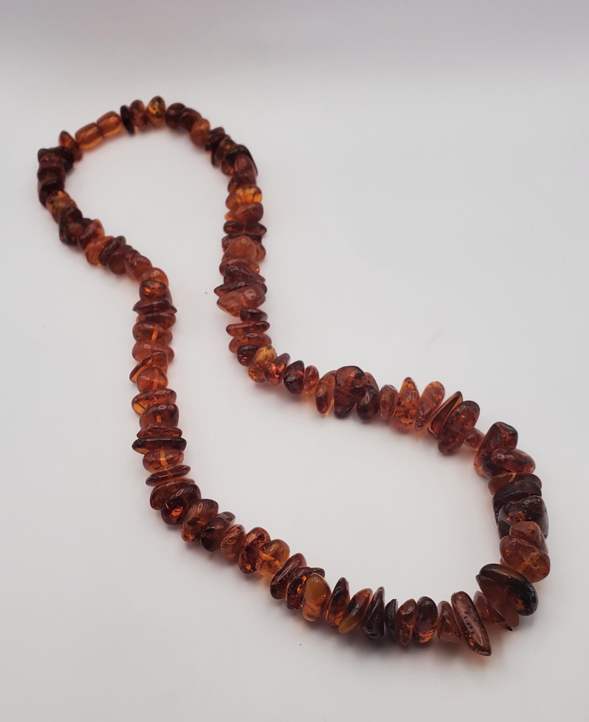 Vintage polished Polish amber bead necklace with a hidden barrel clasp. This beautiful graduated strand is from the 1930s and measures 24