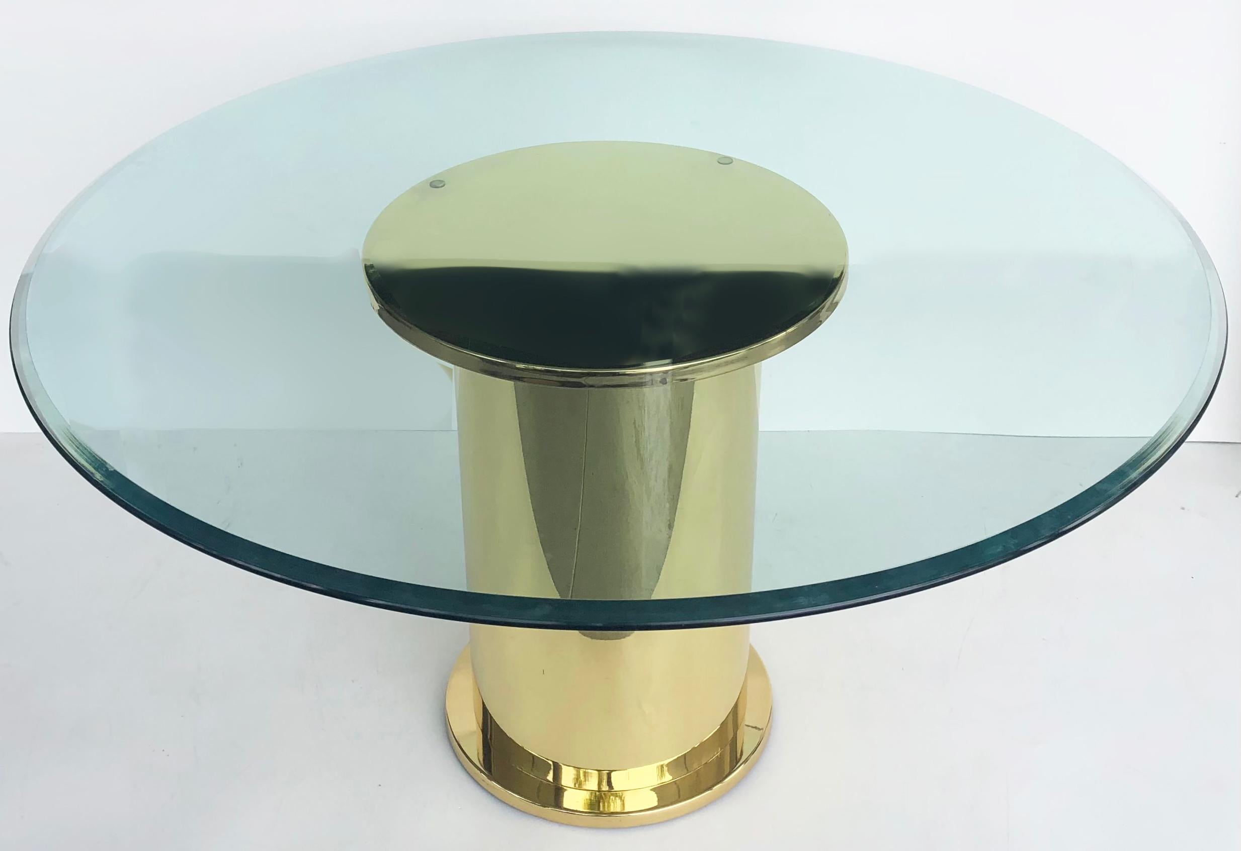 Vintage polished brass dining center table with glass top

Offered for sale is a stunning polished brass pedestal base dining or center table with a round glass top. This fine-quality table is substantial and clean-lined yet elegant.