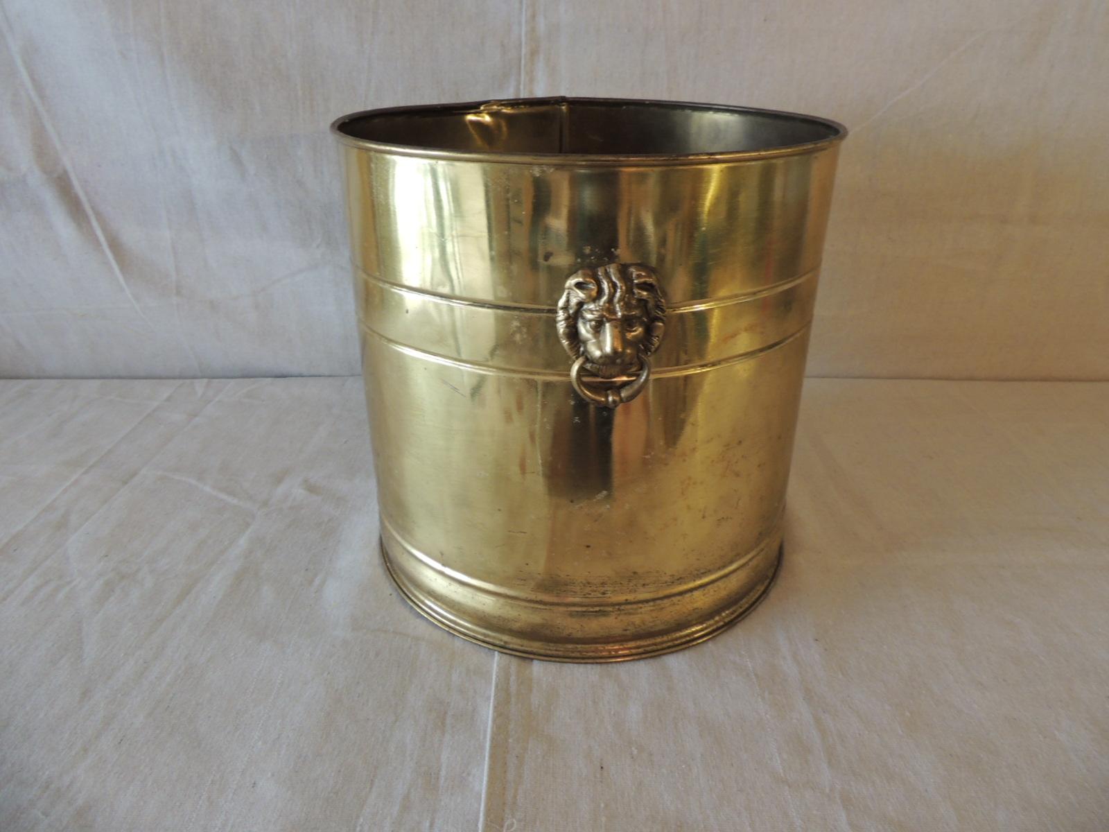 Vintage polished brass round cauldron with lions heads as handles.
Could be use as a planter, wastebasket, magazine holder.
Size: 12