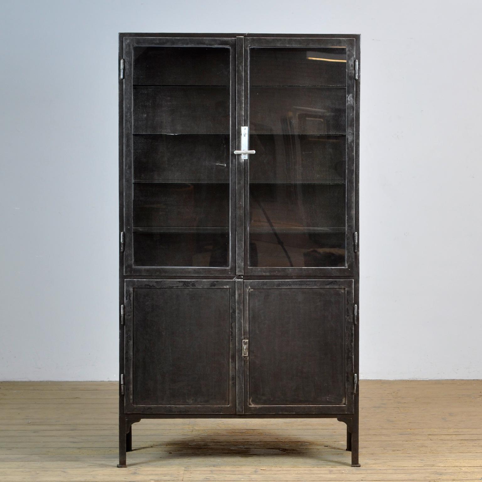 Medical cabinet from the 1930's. The cabinet is produced in Hungary and is made of thick iron and glass. The locks and handle are original and functional. The cabinet has been stripped to the metal and finished with a rust-resistant oil. The cabinet