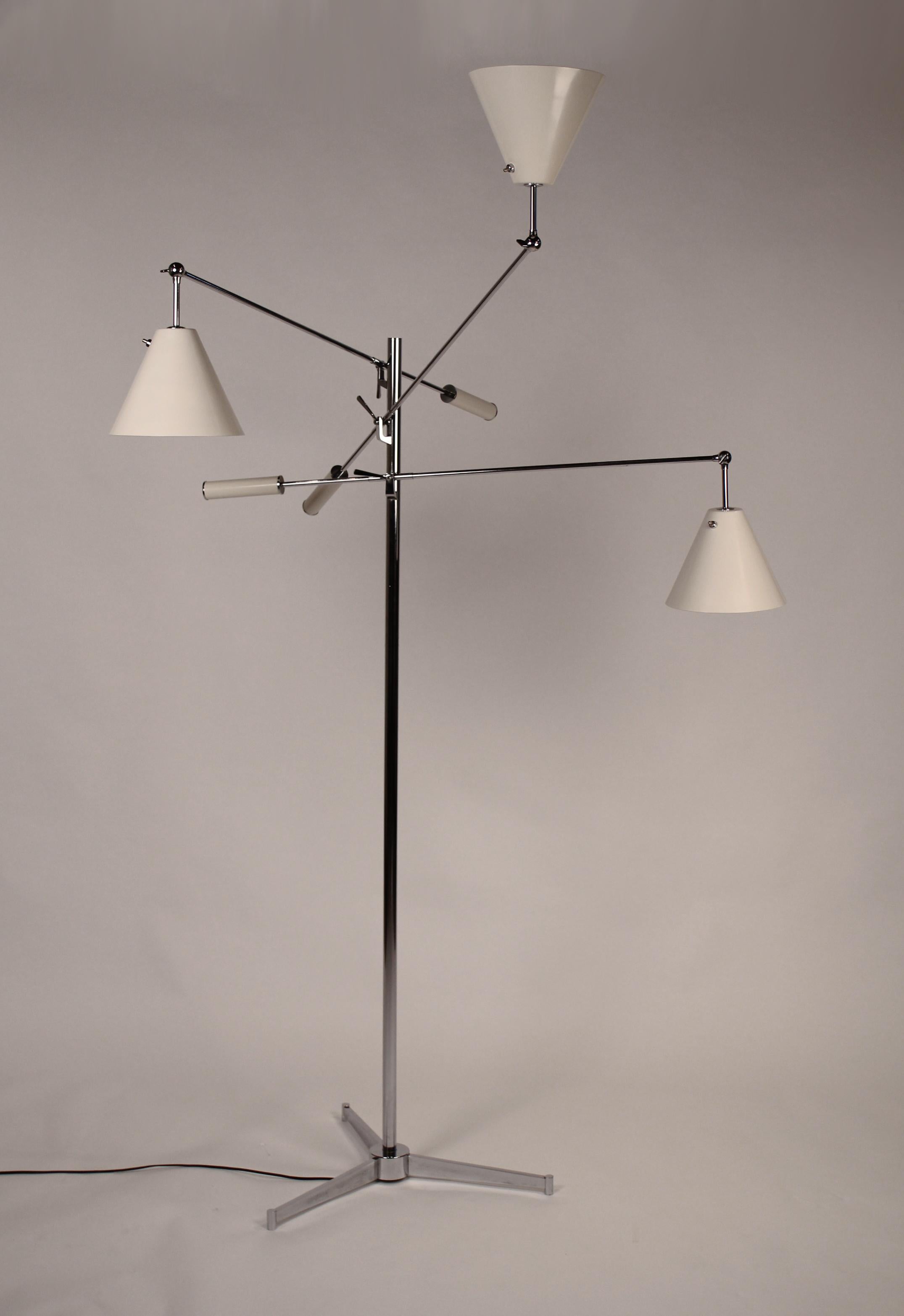 Early Arredoluce floor lamp in an off-white finish with tripod base designed by Angelo Lelii. Fully rewired and ready for installation. Signed to interior of shades.