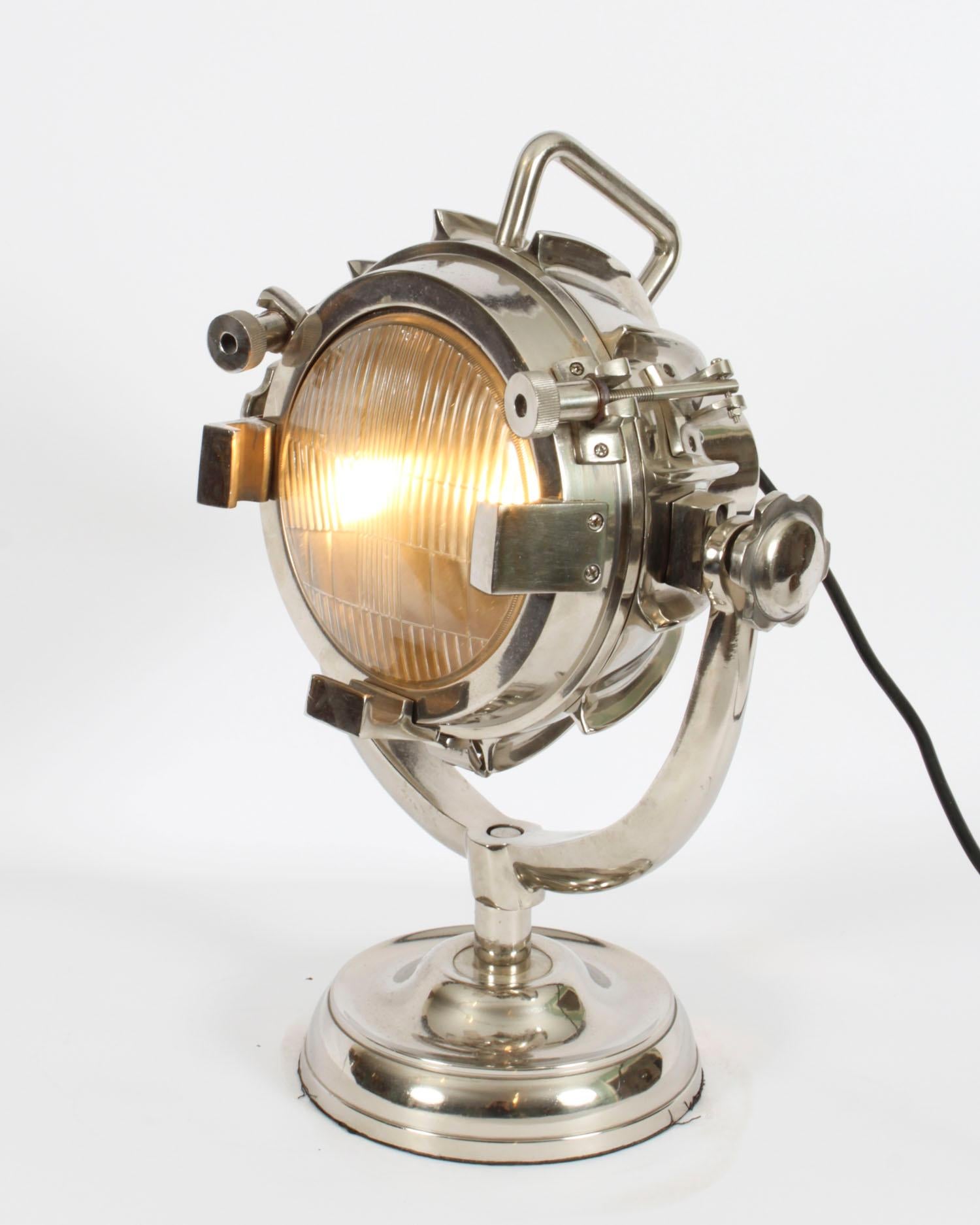 This is a highly attractive Searchlight table lamp, Mid-20th Century in date.

This splendid nautical-inspired swiveling table lamp is crafted from polished nickel.

The craftsmanship is second to none throughout all aspects of this lamp and it