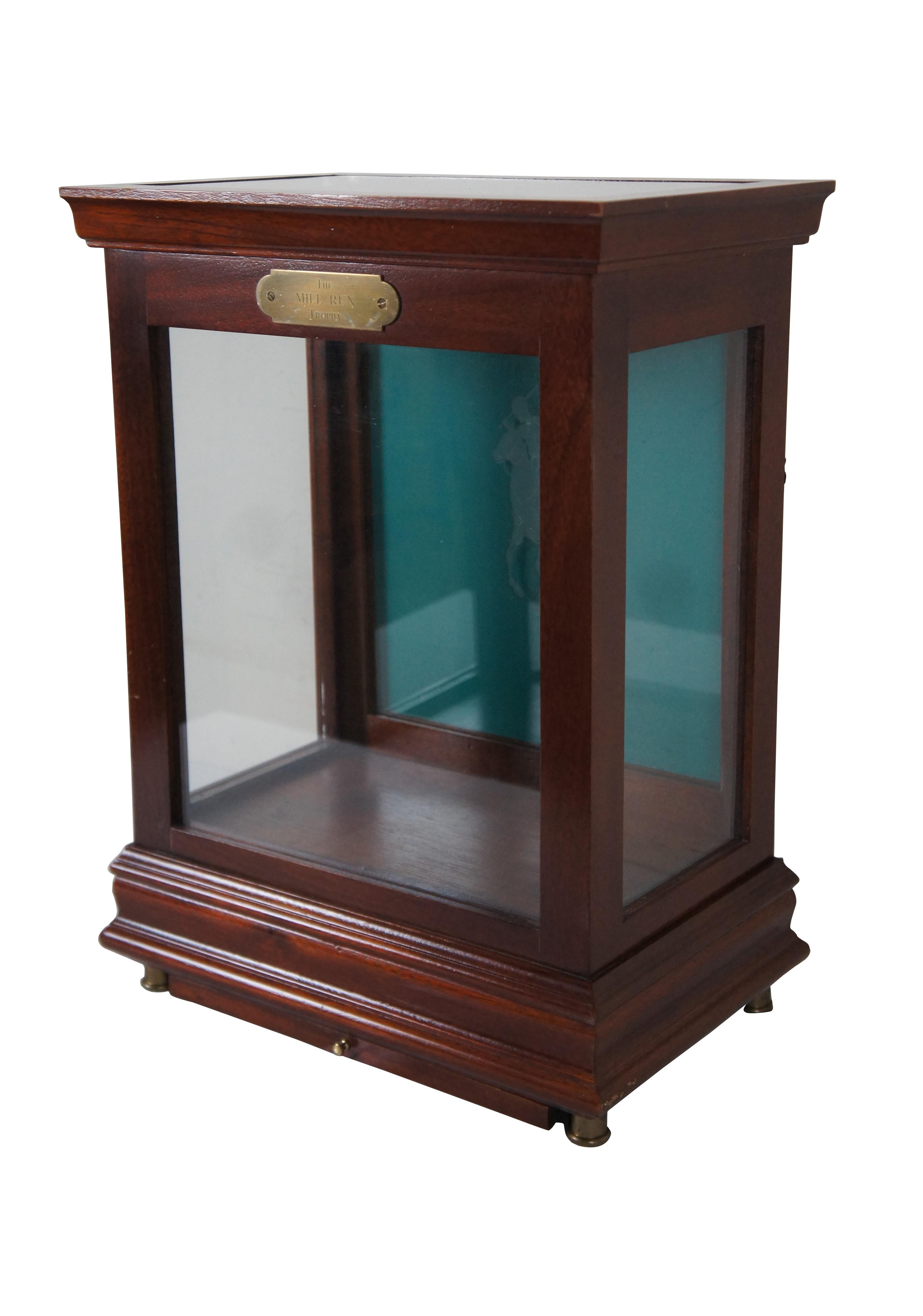 Polo Ralph Lauren tabletop display case made of mahogany with brass feet, small drawer at base, and glass sides and removable glass top. The removable back of the interior is colored robin’s egg blue with a glass overlay featuring the etched image