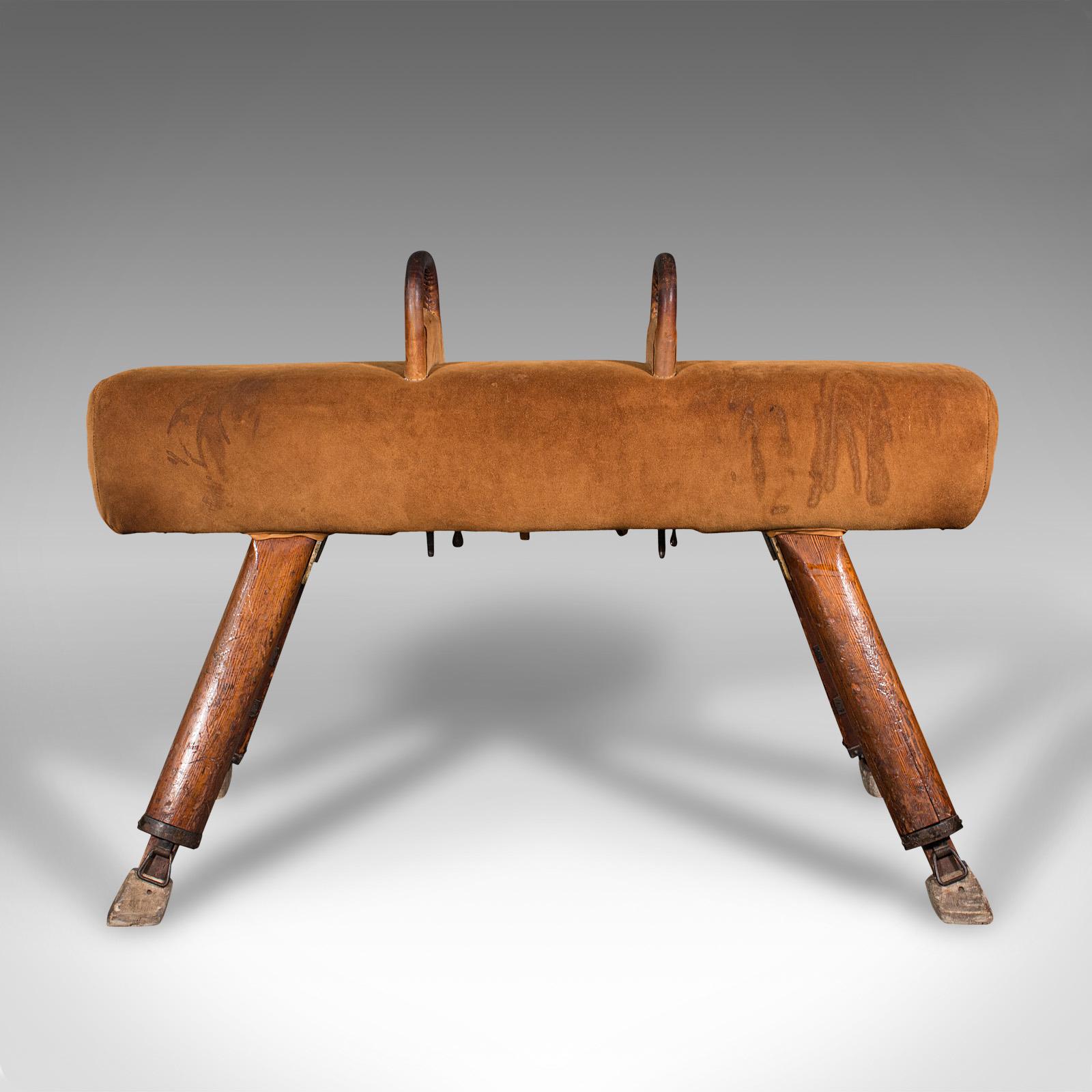This is a vintage pommel horse. An English, suede and pine gymnasium vaulting apparatus, dating to the early 20th century, circa 1930.

Delightfully solid horse as good to use today as it was 90 years ago
Displays a desirable aged patina with