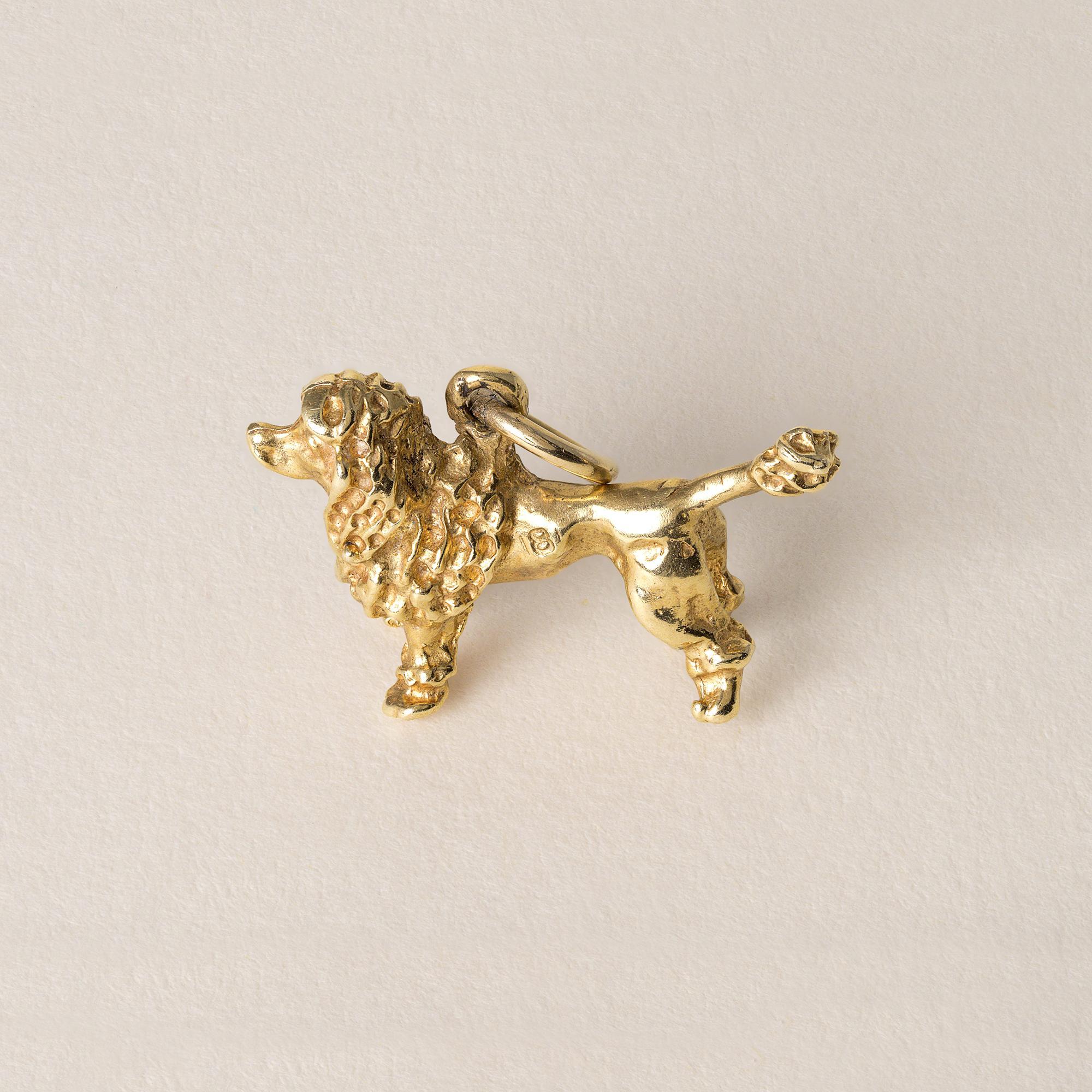 Vintage poodle dog in dog show ready stance.
Circa 1960s
4.7 grams
0.70 inch from nose to tail x 0.50inch
Stamped 18K on side of body