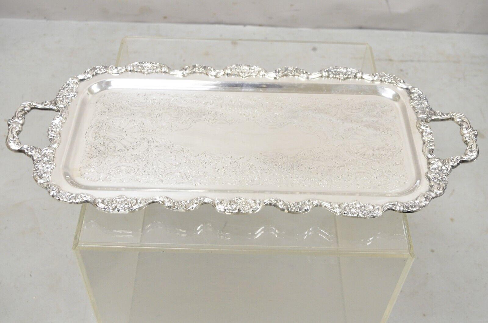 Vintage poole silver co fancy twin handle silver plated narrow platter tray. Item features a nice narrow form, twin handles, raised on fancy feet, etched decorated center, original stamp, very nice vintage item. Circa Mid 20th Century. Measurements: