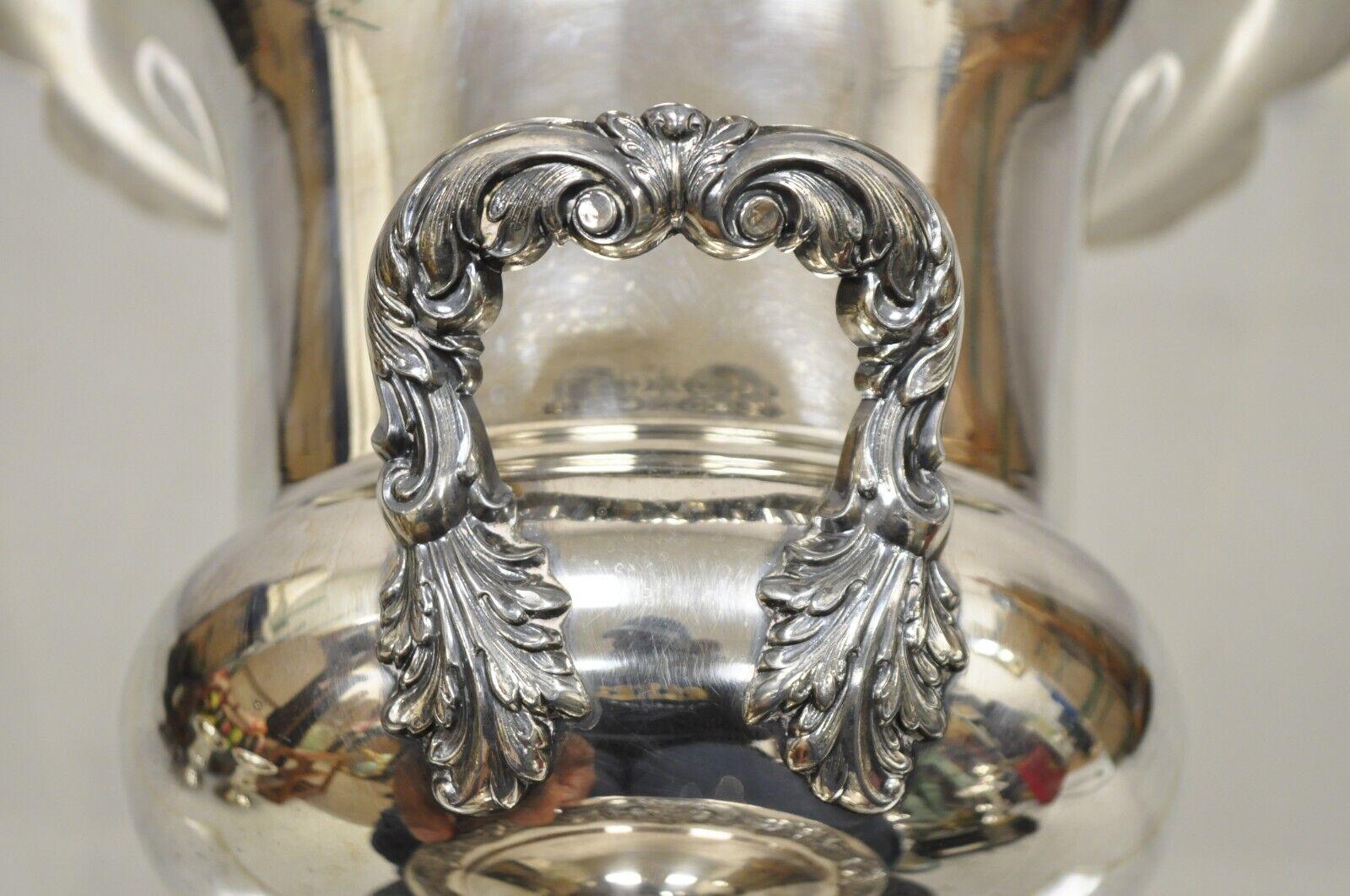 Vintage Poole Victorian silver plate champagne ice bucket wine chiller with liner. Item features a removable aluminum liner, ornate twin handles, decorated rim, circa early to Mid-20th Century. Measurements: 11