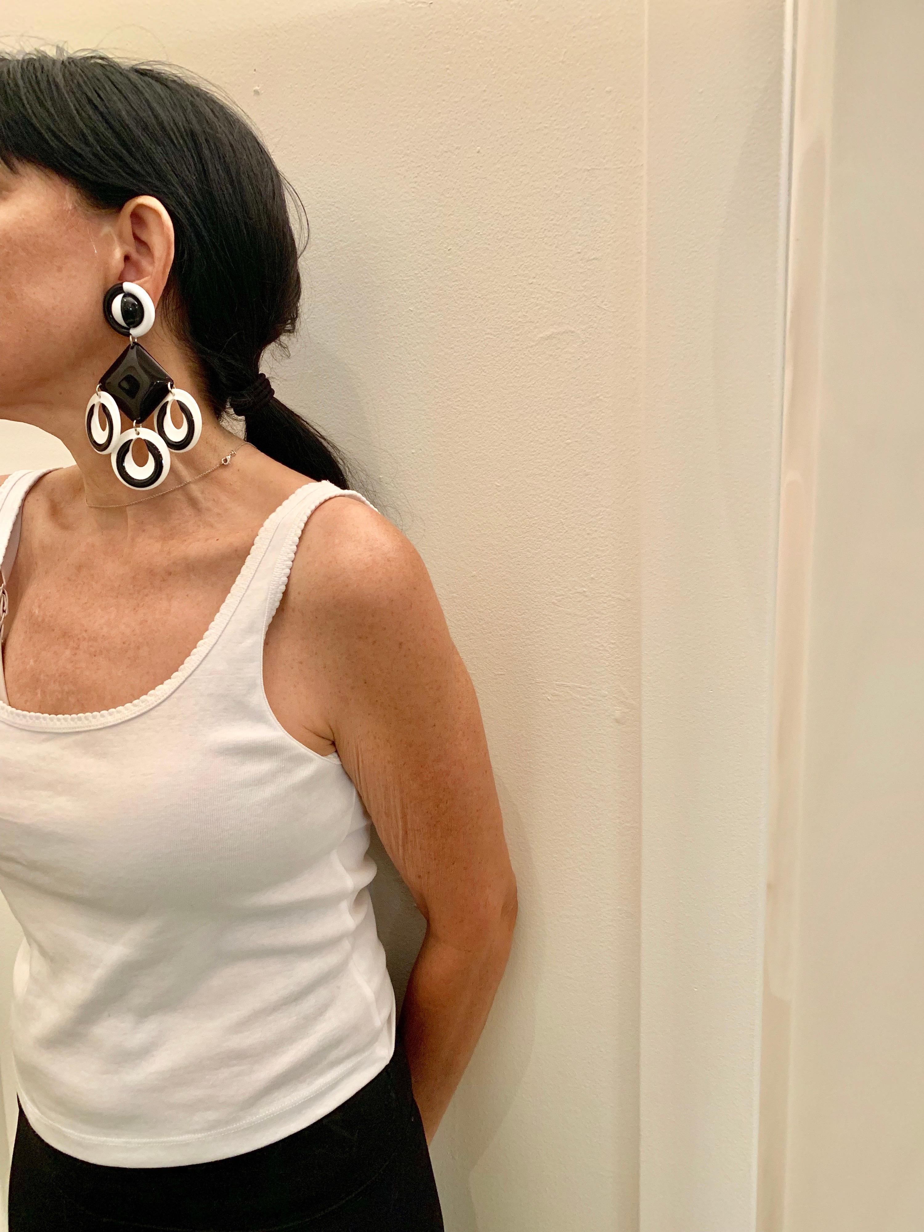 Vintage contemporary/modern pop-art black and white statement earrings - the clip-on earrings are comprised out of black and white resin segments and feature a bold geometric pattern, circa the 1980s.

Note: Extremely lightweight and comfortable to