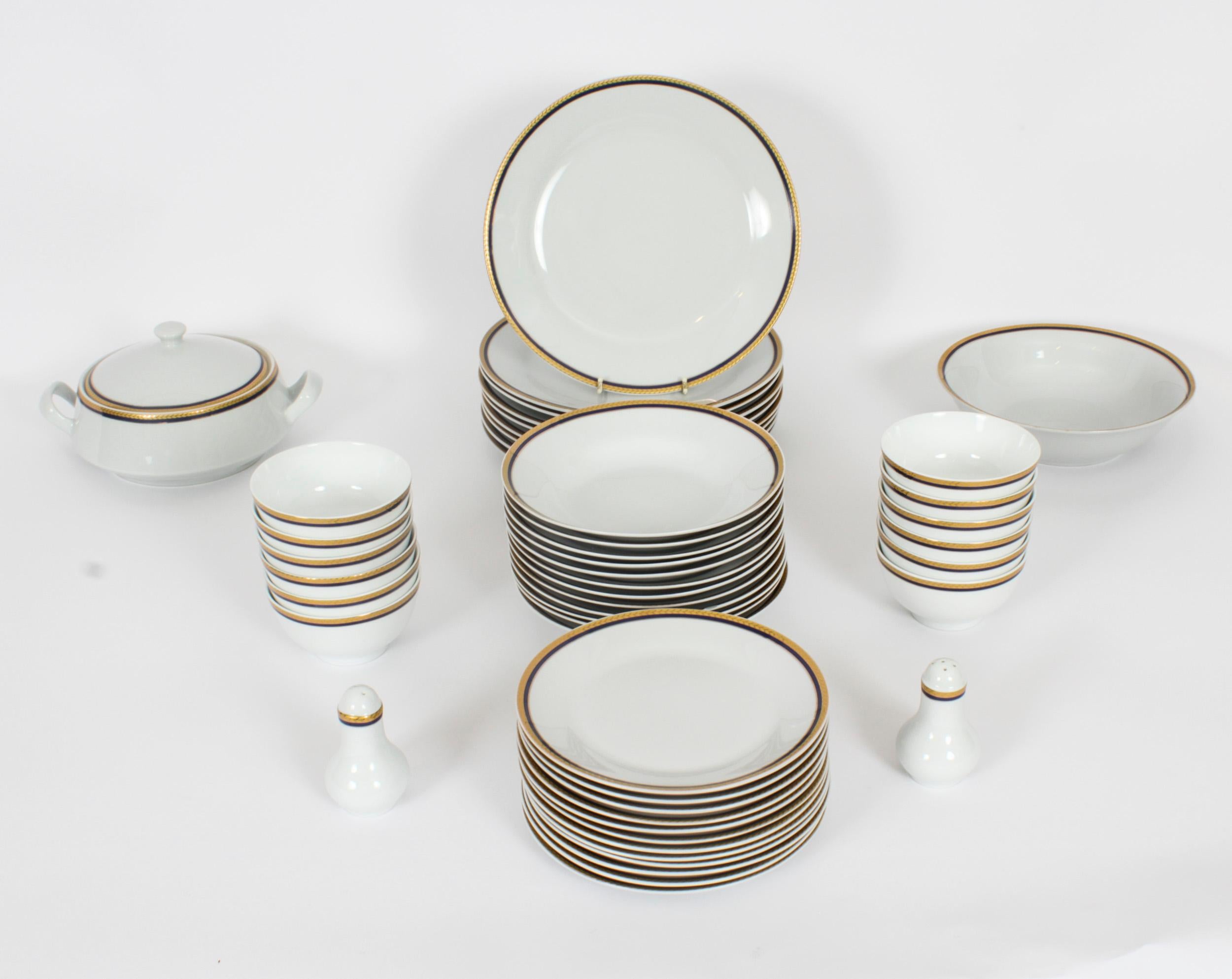 This is a elegant vintage porcelain 77 piece dinner service dating from the late 20th century.

Of fabulous white porcelain with gilt and blue outlines, the service is complete for twelve place settings.

The set compromises :

1 Lidded