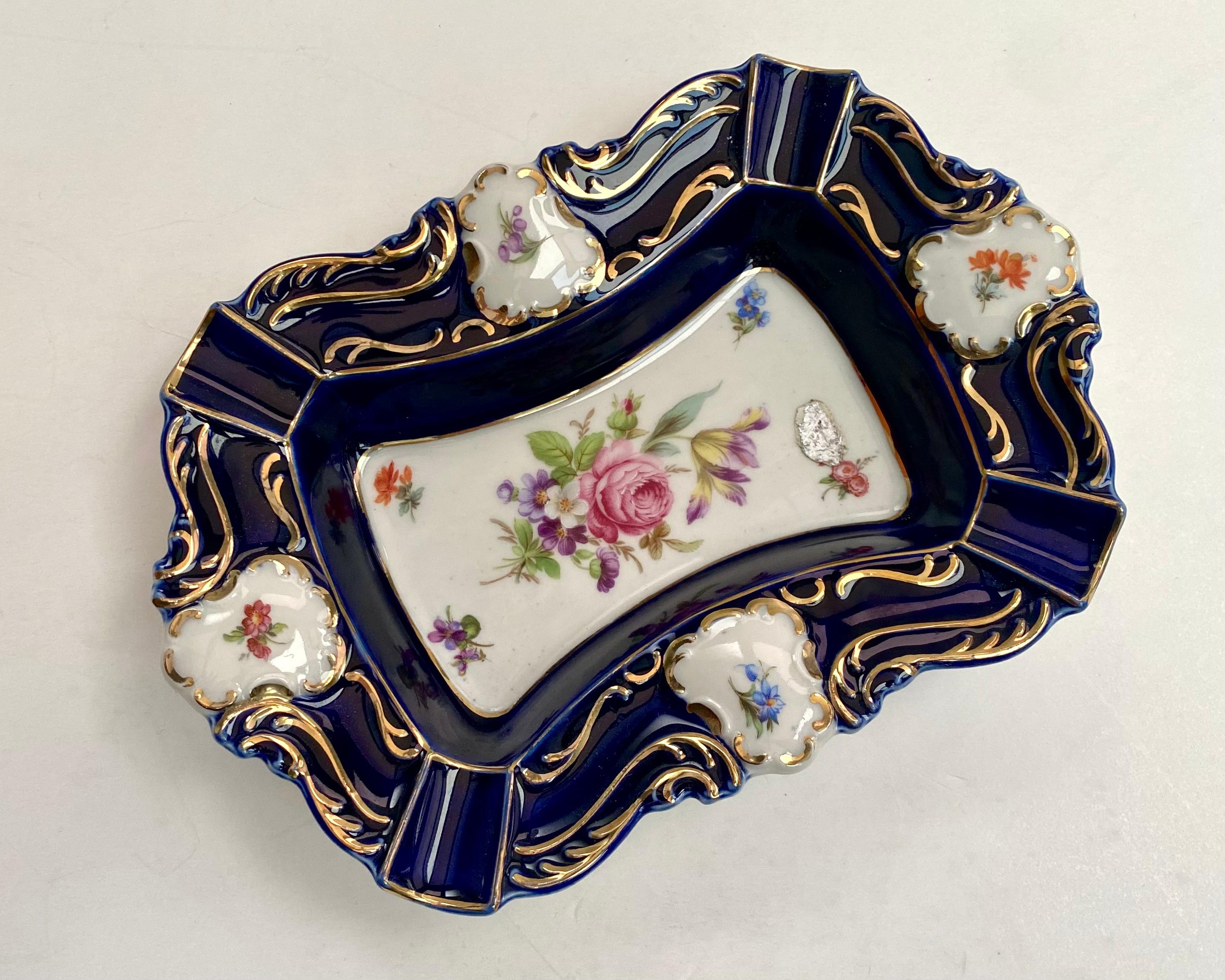 Vintage rectangular ashtray/empty pocket by Lindner, France. 1970s.

Luxurious ashtray made of wonderful porcelain with Bouquet decor, cobalt, gilding with 24 carat gold.

Decorated with hand-painted Meissen roses decal.

The smoothness of the lines