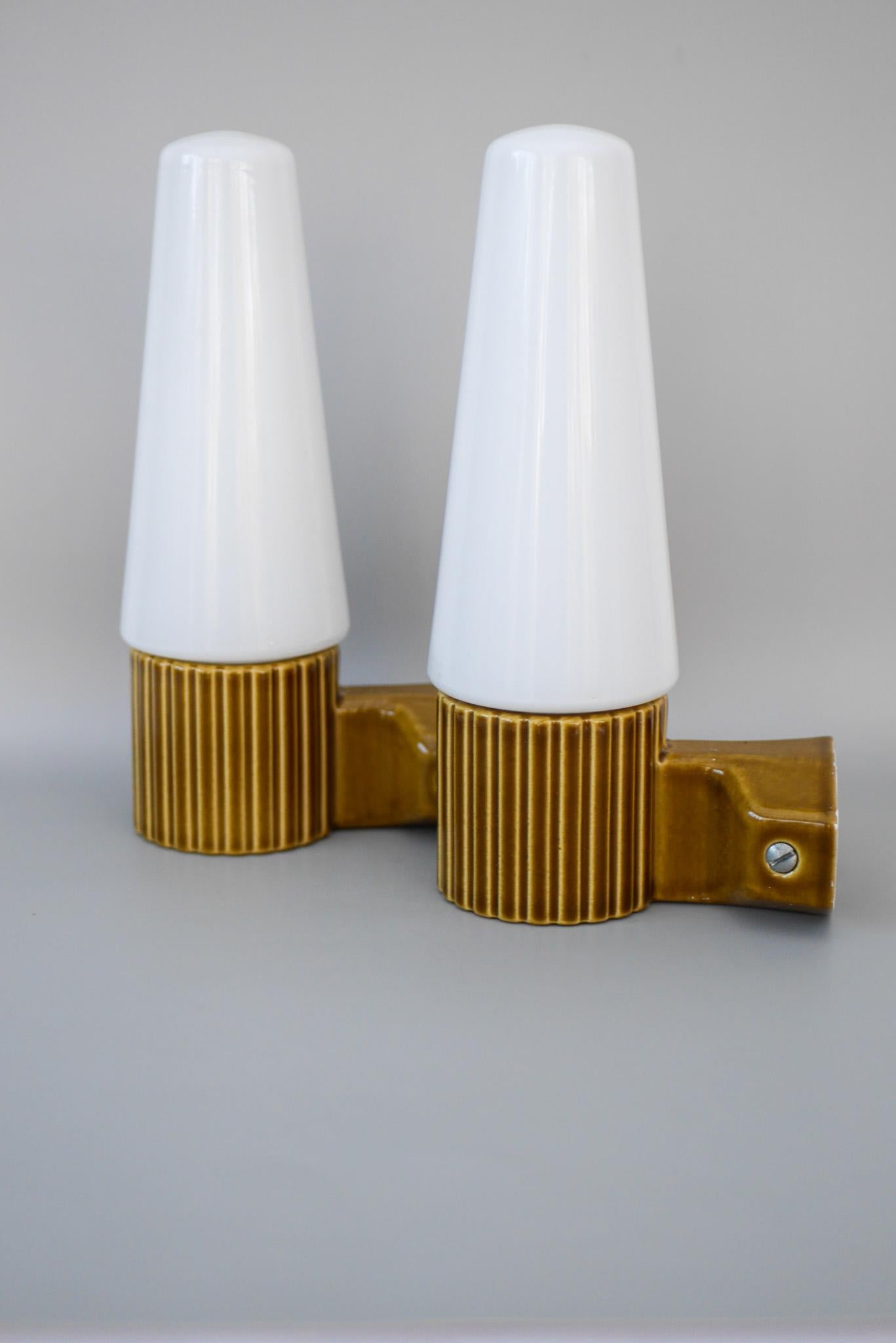 A beautifully preserved pair of mid-century wall sconces designed by Hans-Agne Jakobsson for the iconic Swedish lighting manufacturer IFÖ. These refined fixtures exemplify Jakobsson’s minimal yet warm approach to Scandinavian lighting, featuring