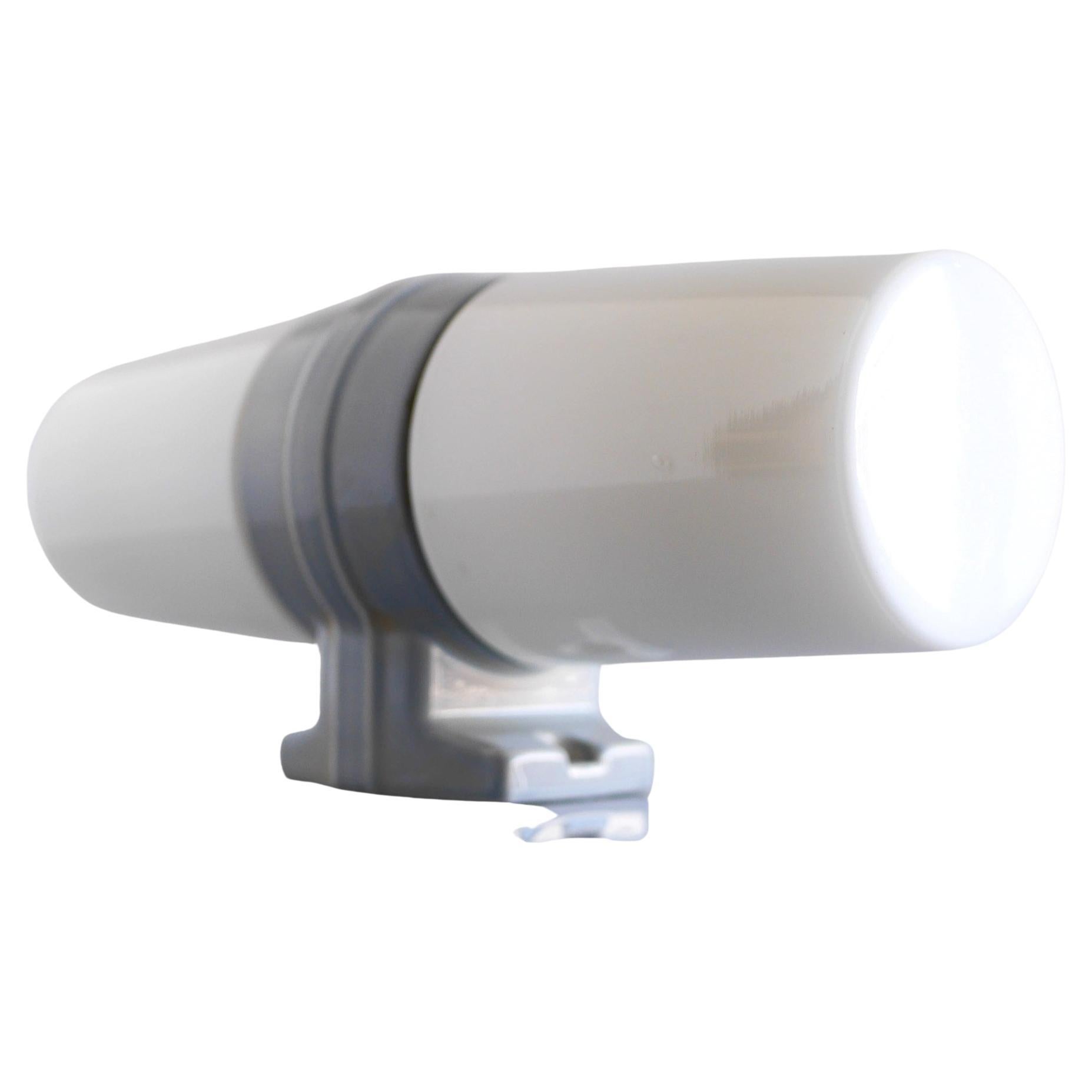 This is a classic mid-century modern vintage double porcelain wall sconce for bathrooms. Produced in the 50s by IFÖ, Sweden. This is a very solid sconce with a streamlined design. The lamp has a porcelain base in a fantastic pale grey color and two