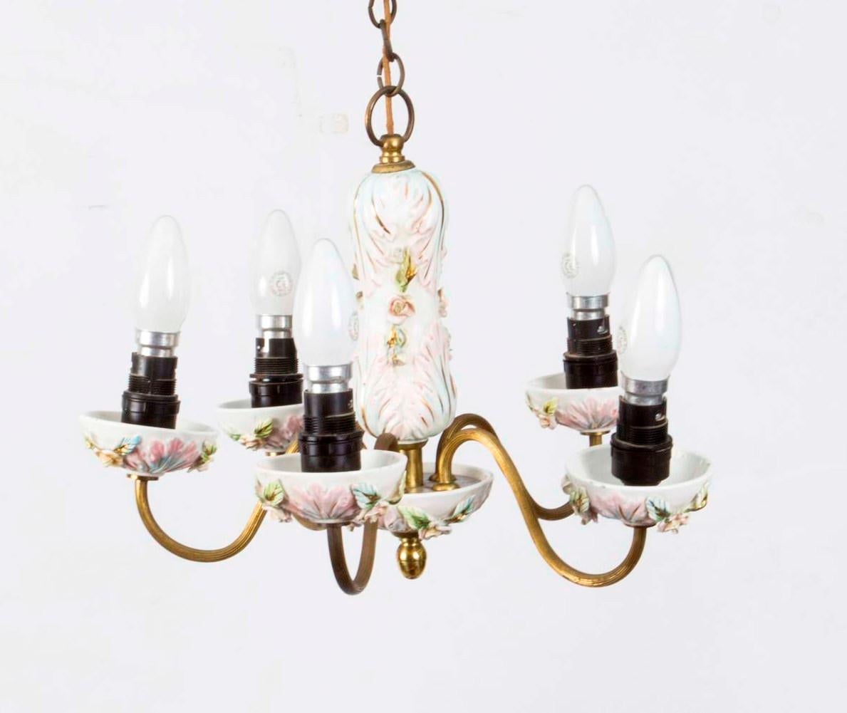 This is a beautiful vintage porcelain and brass four light chandelier decorated with garlands of flowers, in Dresden style and dating from the mid-20th century.

I bought this from the hallway of a large 1920s house set behind a gated entrance in