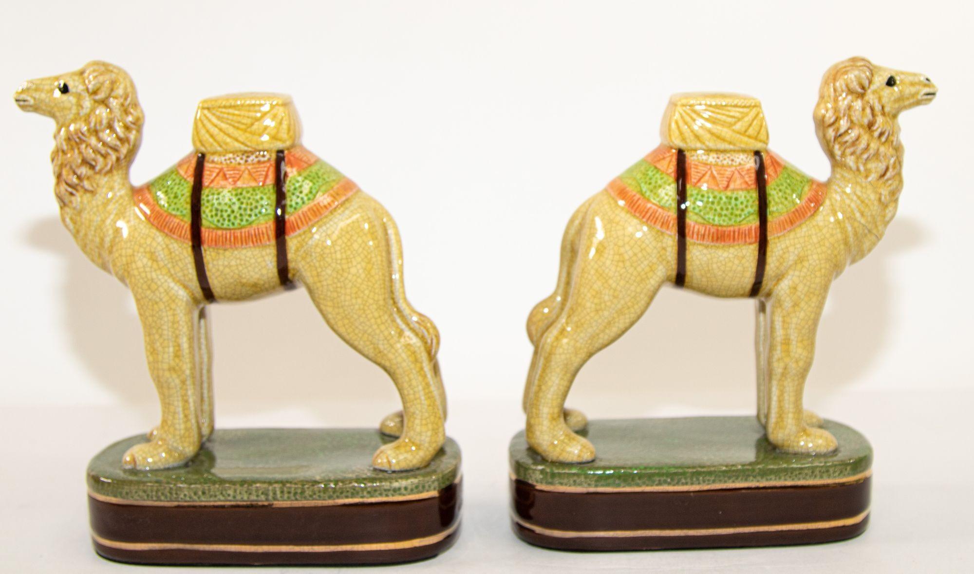 Vintage porcelain camel sculptures figurines bookends.
Collectible pair of porcelain standing camel on stand bookends. Yellow, orange and green colors.
Historically, the Camel would have roamed throughout the deserts of Northern Africa.
Today,