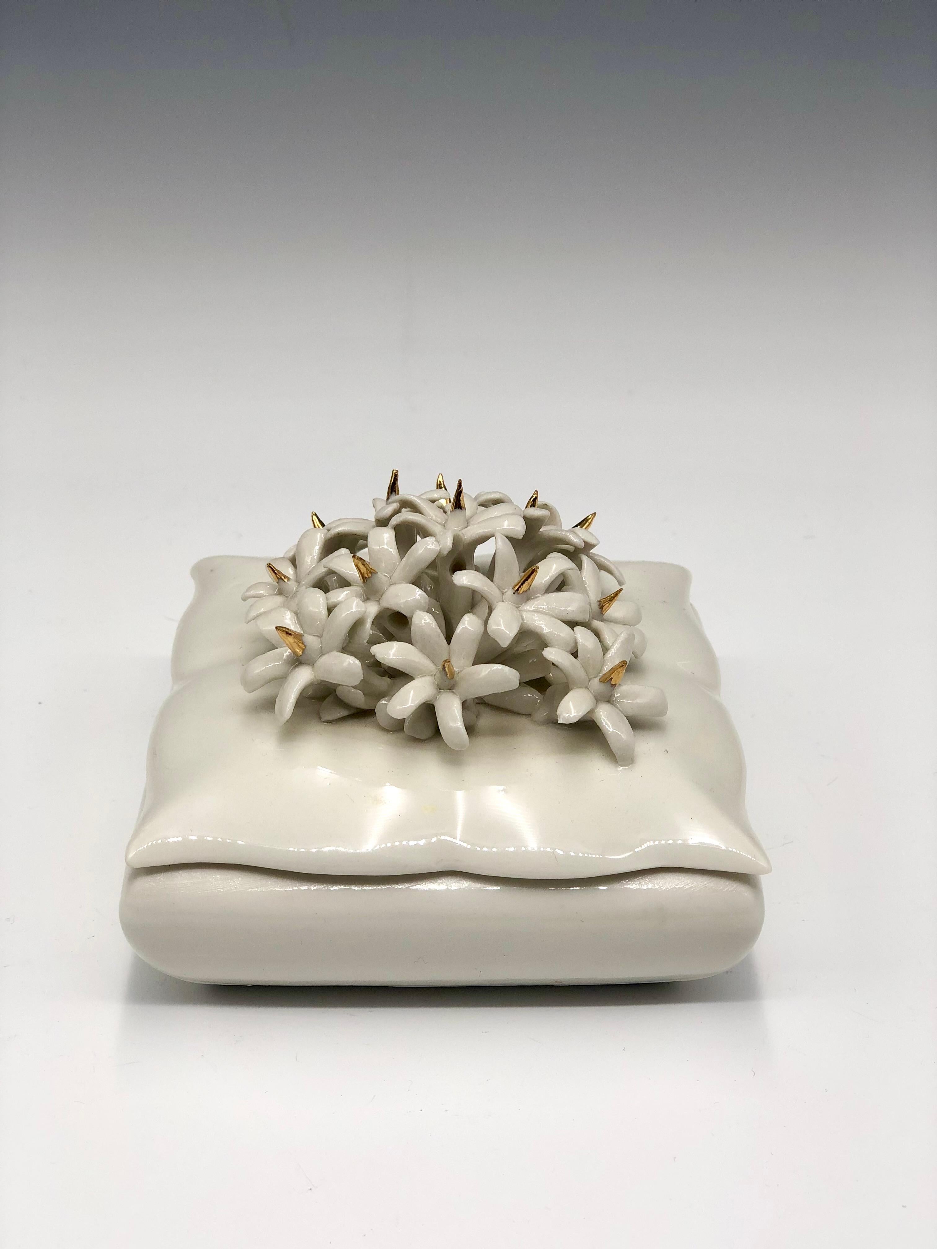 Exquisite vintage white Capodimonte square porcelain trinket box with floral detail lid. Simple and elegant, the box lid is adorned with sculpted white flowers with painted 24k Gold spike details. The item has a blue-crowned 
