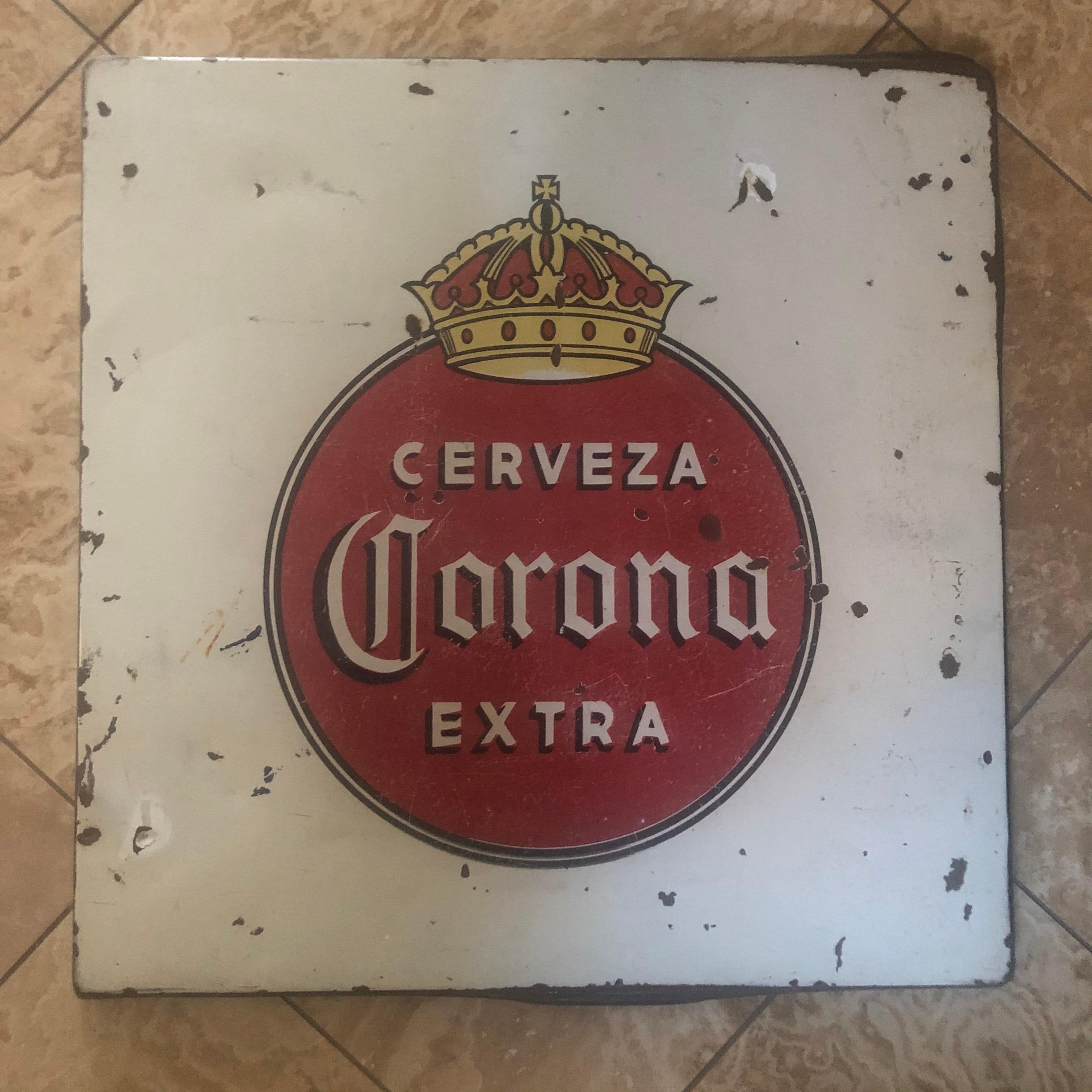 Super cool and hard to find vintage porcelain Corona beer sign, circa 1970s. The sign is actually a former table top at a roadside cantina in Mexico. The distressed look and vintage patina make this piece a great addition to any bar or game room!