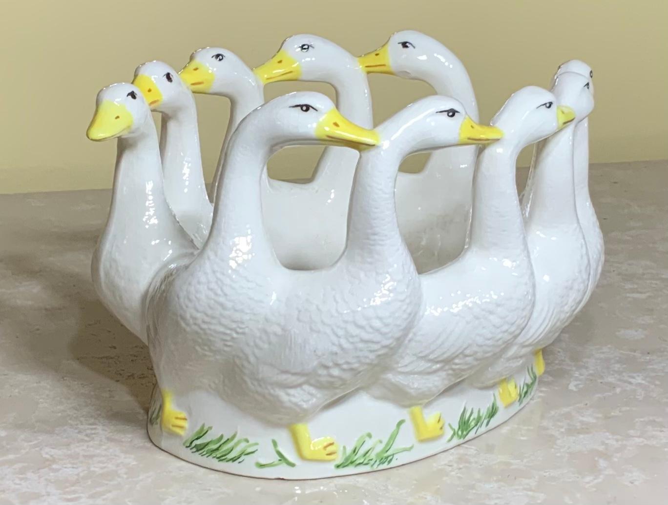 Beautiful candy dish made of porcelain of ducks back to back each other in a circle, vive details on a Snow White color yellow and green some fading in the Center due to age.
Sign in the bottom CT.