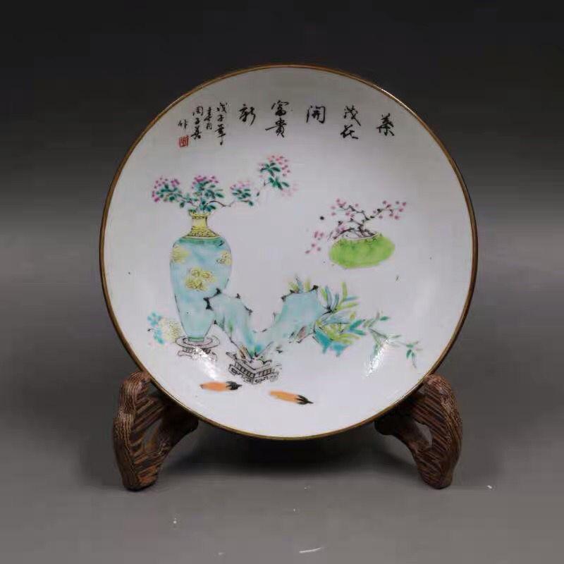 This Vintage Porcelain Famille Rose Flowers Plate is a beautifully crafted masterpiece showcasing the elegance of traditional Chinese artistry. Adorned with vibrant hand-painted floral motifs in the iconic Famille Rose palette, this plate