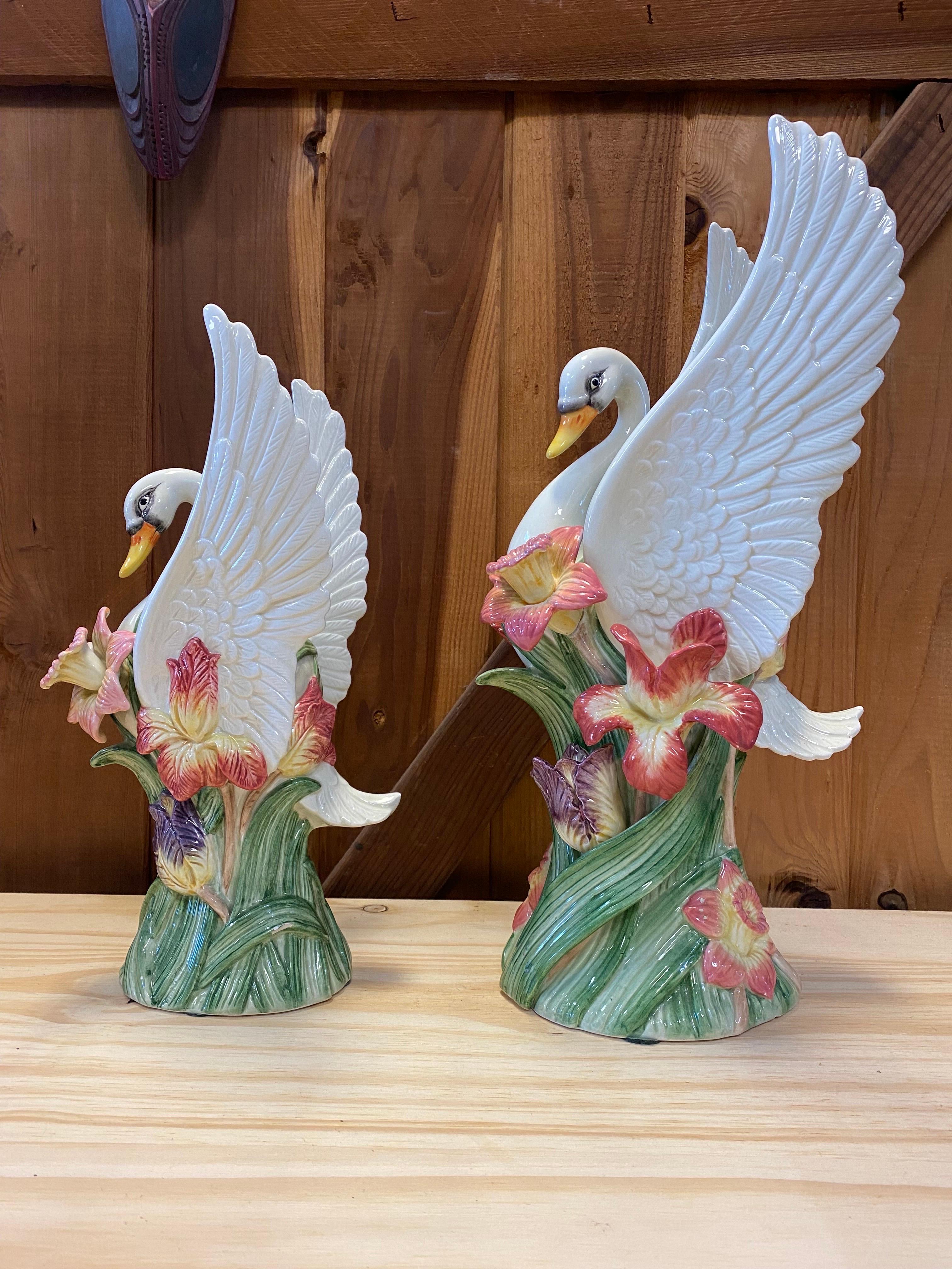 Beautiful set of 2 porcelain swan vases stretching their wings and surrounded by flowers, made by Fitz and Floyd. Both vases are in excellent condition except for a small chip on the tail of the large swan which you can see in picture 7. 

The large