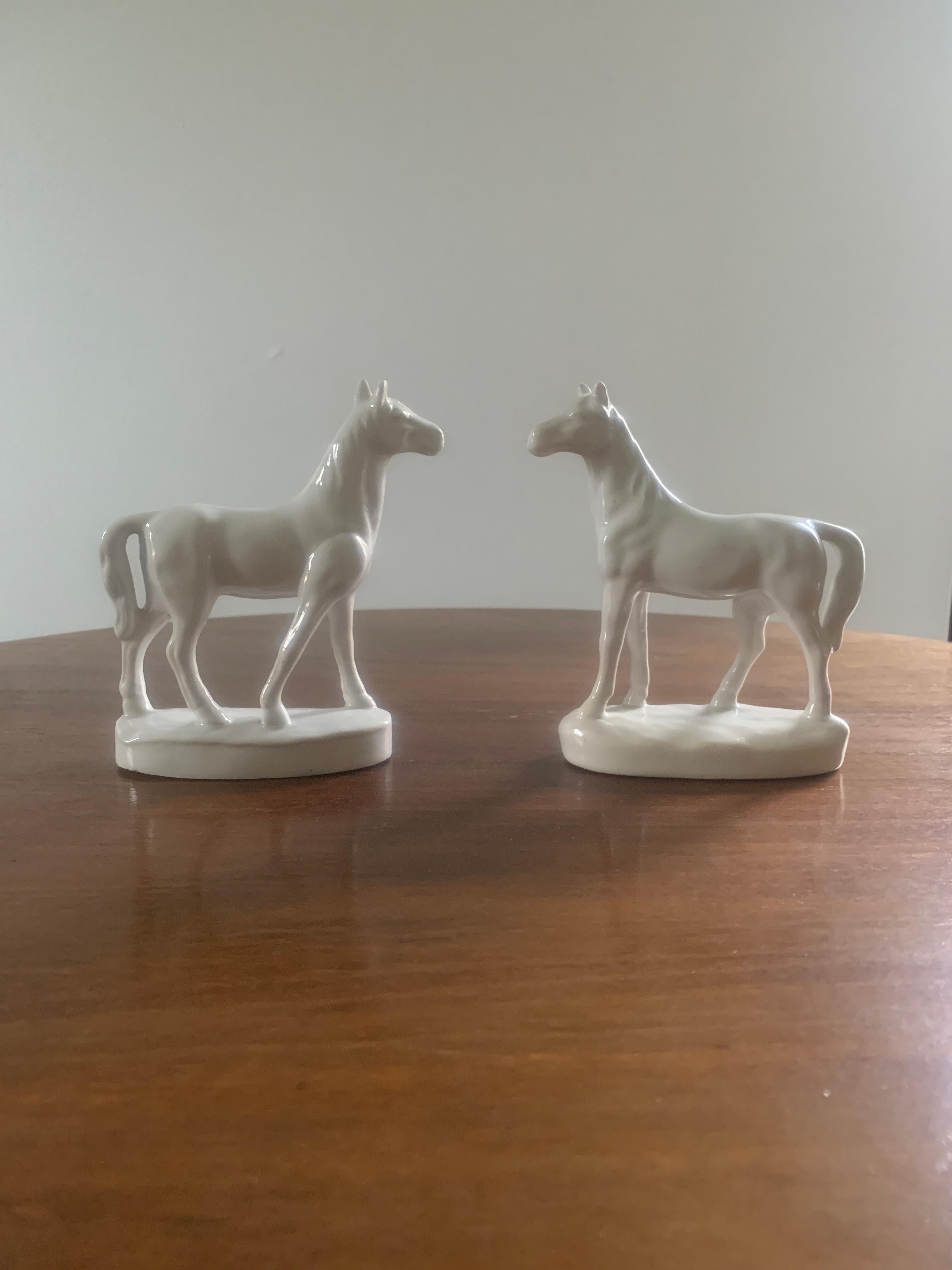 A pair of vintage white porcelain horses.