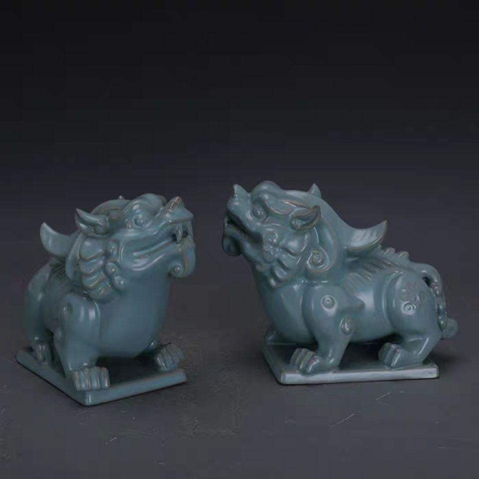 Vintage Porcelain Ru Kiln Celadon Asian Lions Sculptures (Pair) – A Symbol of Protection and Power

Elevate your space with this exquisite pair of Vintage Porcelain Ru Kiln Celadon Asian Lions Sculptures, representing strength, protection, and