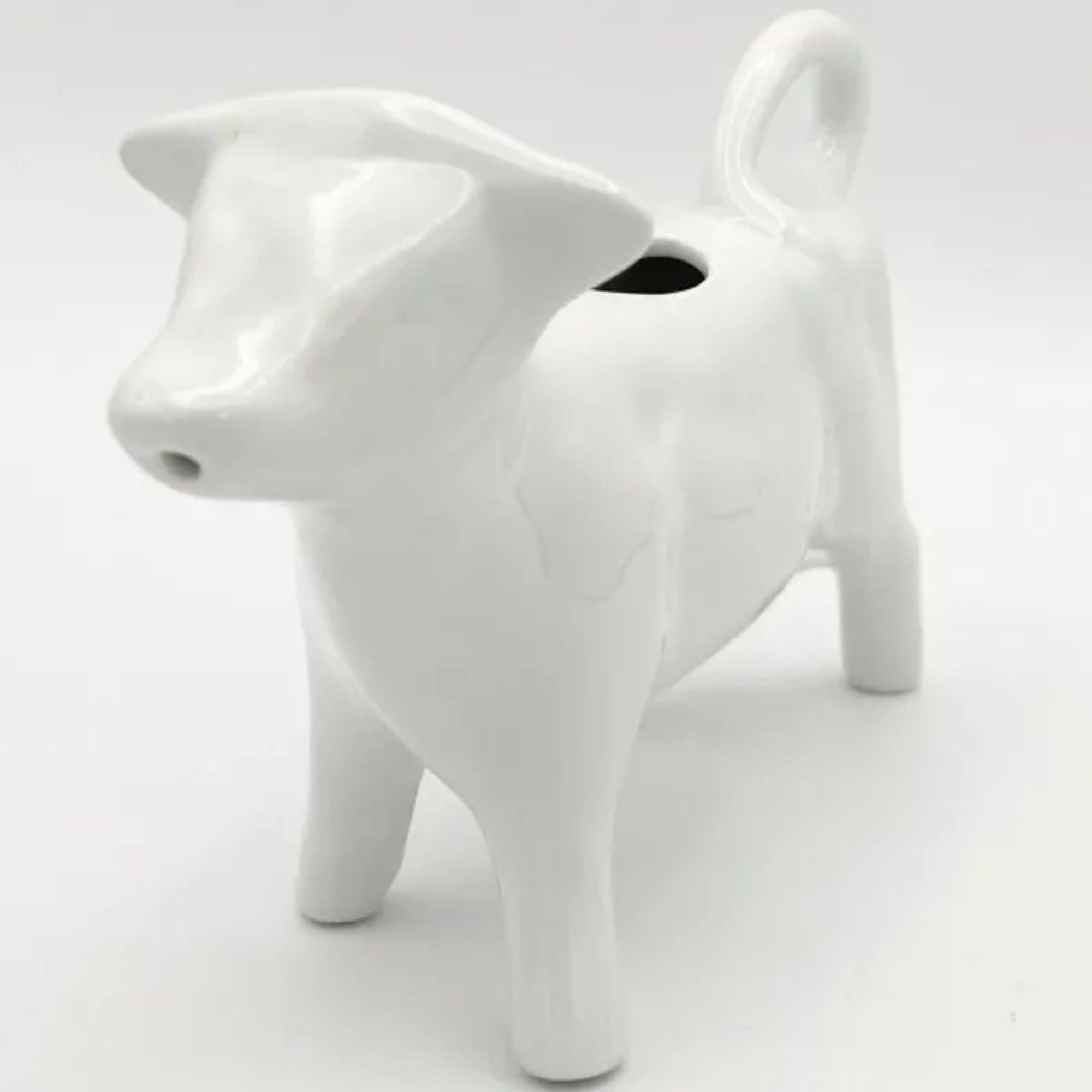 Perfect white creamer in the shape of a milk cow.

Additional information: 
Material: Porcelain
Color: White
Style: American, Modern
Time Period: 1990s
Dimension: 7ʺ W × 2.5ʺ D × 4.5ʺ H