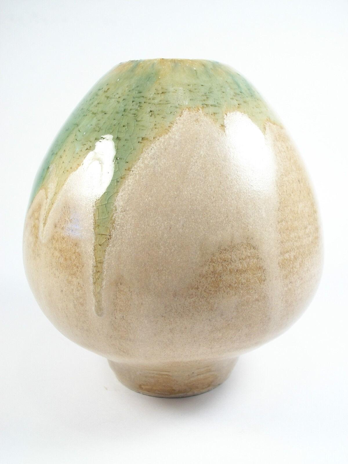 Vintage - studio pottery - Mid Century Modern - wheel thrown porcelain like stoneware vase - tapering to a narrow foot - with a taupe colored glaze as well as a gloss green volcanic drip detail to the rim - marked on the base with the