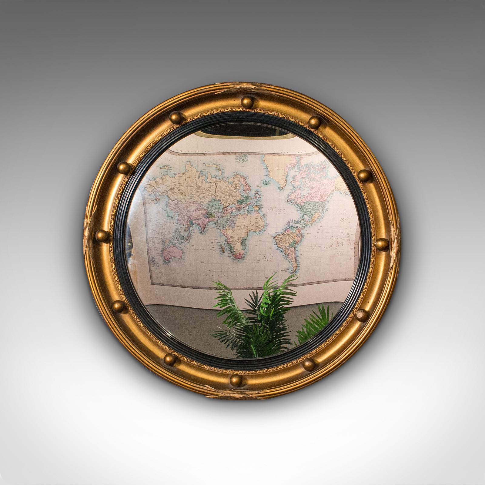 This is a vintage porthole mirror. An English, mildly convex decorative hall or lounge mirror in Regency revival taste, dating to the mid 20th century, circa 1940.

Charming mirror of petite proportion and colourful finish
Displays a desirable